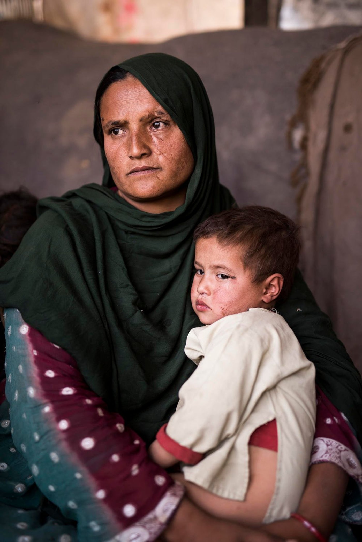 Zagari, 30 years old from Shinwar district in Nangarhar, fled from her home 4 months ago to Kabul, when militants entered her family home and demanded their assets - her carpets, her jewellery, their livestock, everything. "All we could take was our clothes and a few blankets,' she said. She has six children, and altogether they paid around $300 for transport to Kabul - a loan which they are struggling to repay. She and her family now live in a tiny, half built mud home with little more than a kettle, a couple of blankets, and a tarpaulin for the ground, in Kabul's sprawling informal settlements (slums). Some of her children earn money for the family by collecting trash for recycling. Her children are constantly ill from the poor sanitation, and only get to go to school for one hour each day. "Usually we only get to eat bread each day, only sometimes do we get something nutritious like vegetables," Zagari said. Zagari couldn't even comprehend a question about the future - "we just live here day by day. All I think about is how I can protect my children."
Photo credit: Janus Engel Rasmussen