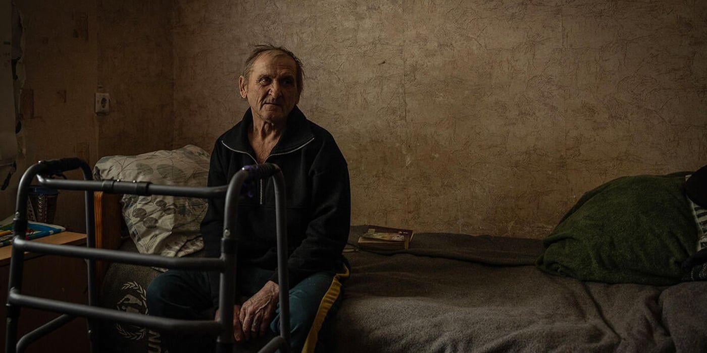 Man sitting on a bed.