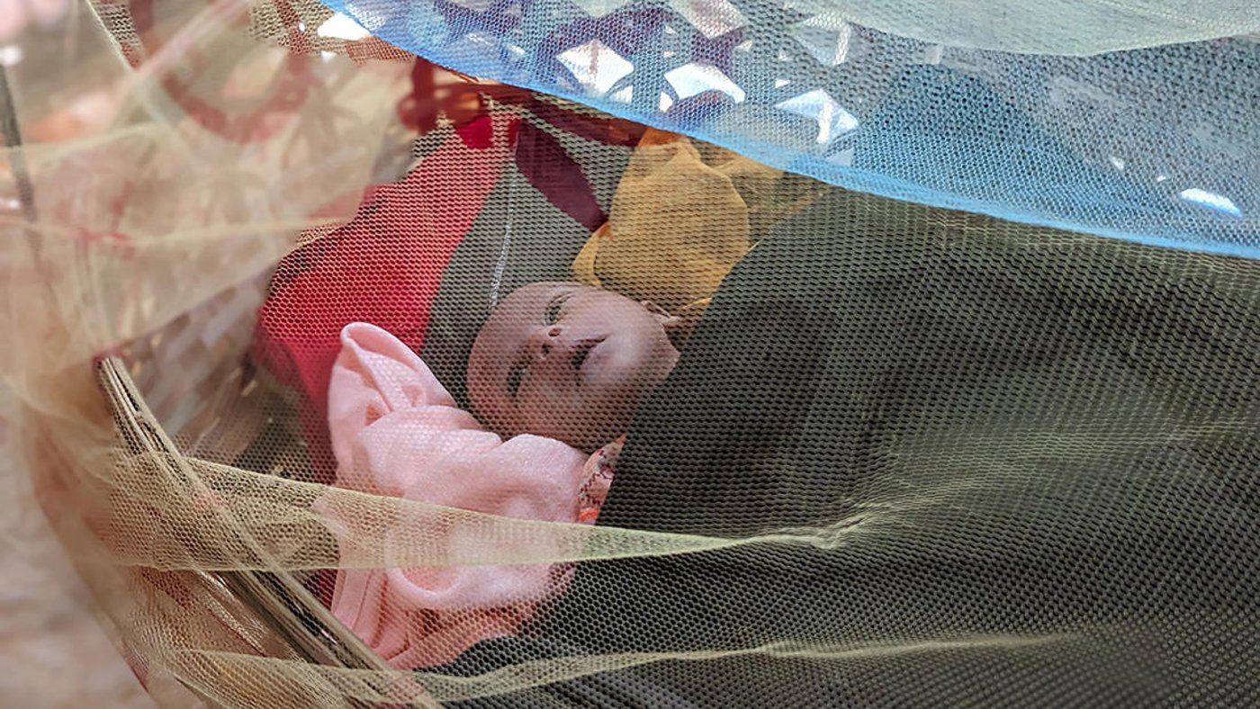 Baby in a cot.
