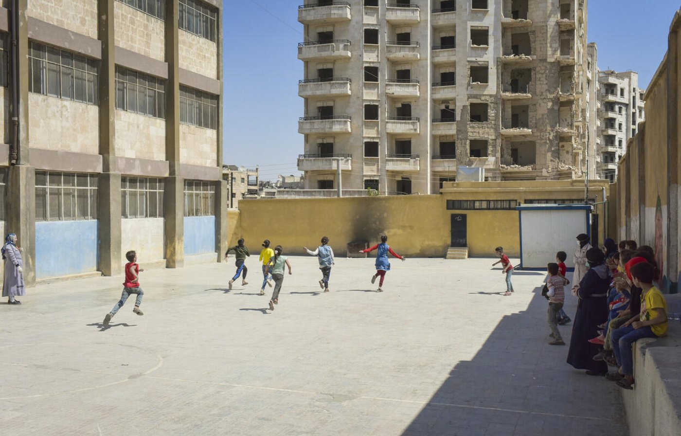 Children running in a school yard during recess. 