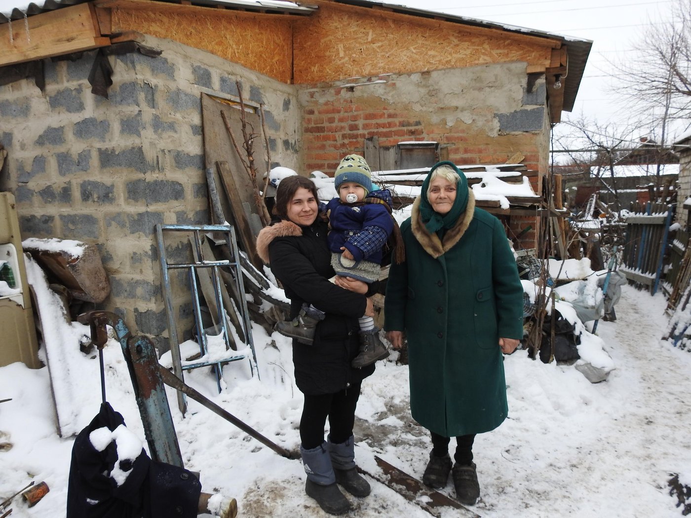 The house of 29-year-old Natalia Sokolova was one of the first, which was hit by hostilities in Stanytsia Luhanska: the roof and walls were significantly damaged. For more than three years, she lived in a small summer kitchen with her 70-year-old mother and small son, until in 2017 they received assistance from the Norwegian Refugee Council (NRC) under financial support of Vatican’s Initiative “Pope for Ukraine”. 
“In the summer of 2014, I went to work. My mother stayed at home.  She went out into the yard to look at the vegetable garden, but did not reach  she fell from the blast. The shell hit the house and almost destroyed it. The same day four more houses were damaged at our street. It was only the beginning of war,” Natalia recalls.
Natalia and her mother Vira moved to live in a small summer kitchen near the house. They sought help from local authorities. Unfortunately, there was no money in the local budget. The situation was complicated by the fact that Natalia was pregnant and very worried about where and how she would live with her baby.
"When Savelii was born, only summer kitchen was suitable for living. However, it was very cramped and cold. In such circumstances, the baby started to catch up diseases, and we spent several months in hospitals. After discharge, we decided to go to my father  to the village of Chuhynka, in Stanytsia Luhanska district. We lived there for almost a year, but still did not give up the dream of returning home,” Natalia tells.
Finally, in winter 2017, they were called from the village council and told about housing reconstruction project, which was implemented by the Norwegian Refugee Council with the financial support of the Vatican's Initiative “Pope for Ukraine”.
"At first we couldn't believe it was possible," Vira says. “They believed when they provided us with building materials and money to hire builders. My son covered the roof - he is the builder. We started construction in May and were able to move in after three months when the windows were installed,” Vera smiles.
Now Natalia and Vira are starting interior works, bring in water and equip the bathroom. There is still a lot of work to be done, but this family has numerous plans for the future and happy that they already live in small, but their own house.
In 2017, part of the NRC Shelter projects  in Stanytsia-Luhanska district of Luhansk Region was funded through Vatican's Initiative “Pope for Ukraine”. 150 socially vulnerable families received construction materials to repair their house with minor damages and 13 families received construction materials and funds to rebuild  their destroyed premises.
Photo: Anastasiia Karpilianska/NRC