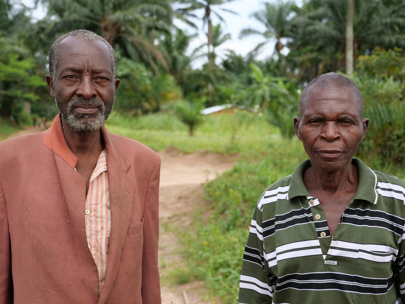 Alphonse Kabasele Bushila poses next to Emile Ndibu, the village chief of Tshiambula. These two village chiefs were in conflict with one another but NRC's efforts at mediation led to these two villages to now be at peace.

Photo: Itunu Kuku/NRC