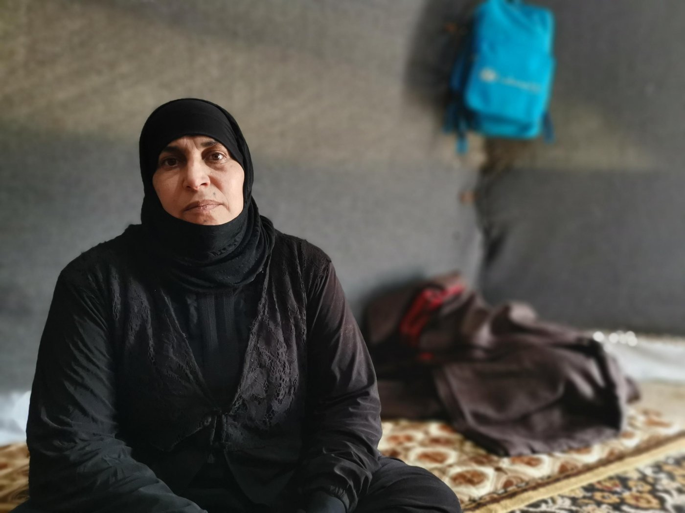 Um Ibrahim – Displaced with six children 

“My main issue now is my identity card and those of my children – they’re old. I cannot cross any checkpoint unless I renew identity cards. As my husband is missing, I cannot get new ID cards without his presence or having the original copy of his ID,” Says Um Ibrahim, 44, from Hawija District in Kirkuk Governorate. 

Um Ibrahim fled with her six children to a displacement camp during the fight against IS. Her husband who was a farmer and the owner of the land and their house has gone missing. During the fight against the Islamic State group to retake Hawija, he decided to remain on the farm and protect the land and livestock. Later Um Ibrahim received information from the people in the village that her husband had been taken by some militias.

“I am afraid if I go back to our home, whoever took my husband might take my children as well or harm them,” she says.

“My family cannot do anything to help me. They are in the camp just like me. We all are from the same village and none of us can return back to our areas of origin. We are only depending on NGOs for support. The only thing that might help us start our lives again is to renew our IDs and get some compensation to start a small project and get an income to be able to live.”

Photo: Helen Baker/NRC