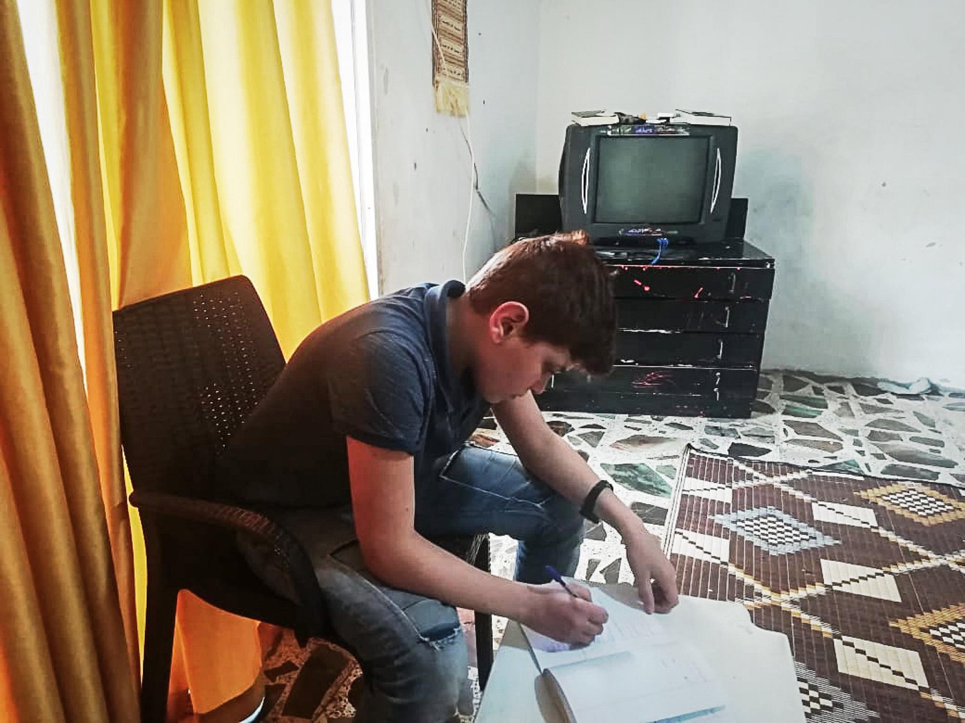 Since the outbreak of the Covid-19 the Norwegian Refugee Council (NRC) have been working around the clock to ensure that refugees and displaced children and youth can exercise their right to quality, relevant education.
Mohammad, 13, is one of these children. He is originally from Hama in Syria but fled to Lebanon together with his family six years ago. Now he lives with his parents, three sisters and three brothers in a small apartment outside Tripoli, North Lebanon.
“Although it has been six years since we arrived here, I still wish we can go back every single day. We could play football as much as we wanted in front of our home and we had a huge yard where no one bothered us,” says Mohammad. “In Lebanon we can never finish a football game, the neighbours always get annoyed and ask us to go back home. Now the situation is worse, we can’t do anything.”
Refugee children are bearing the blunt
When the activities stopped due to the Covid-19 outbreak Mohammad and his brothers were very upset. Going to the NRC learning centre, meeting their friends, and learning was part of their daily routines. “It’s not easy to stay at home, I feel down but there is nothing we can do,” says Mohammad with hesitation.
The Corona crisis has led to closed schools and disrupted the education to more than 1.5 billion learners. Refugees and displaced children and youth are bearing the blunt. Children and young people in displacement have often missed out on years of education already, due to war and conflict, and without any help, school closures due to Covid-19 will make them fall behind even further.
“To meet the needs of Mohammad and 1,200 other children enrolled at NRC learning centres in Lebanon we are now implementing remote learning modalities, including via communication platforms such as WhatsApp, combined with follow-up phone calls to provide guidance and support and to safely refer people to other specialised organisations,” says Rayan El Baf, one of NRC’s child protection technical officers in North Lebanon.
Due to the lockdown and fear of spreading the virus our colleagues are not able to visits the children and their parents. It is Mohammad’s mother, Fatima, that has sent us the photos, and it is our colleagues in Lebanon that have interviewed Mohammed and his mother.
“The remote learning has benefited my children a lot. Instead of leaving them behind during this period, NRC’s remote learning methods show us that NRC continues to care about the education of our children and appreciate their efforts to learn. It helps them connect with their inner selves, it gives them courage and strength to know their own worth,” says Fatima, Mohammad’s mother.
Nationwide lockdown
On the 15th of March, Lebanon declared a state of general mobilization in an attempt to control the spread of the coronavirus. With the nationwide lockdown, the basic survival and protection of the most vulnerable communities in Lebanon has become a critical issue. However, despite the challenges and to minimize the risk of exposure to beneficiaries and its frontline staff, NRC Lebanon continues its essential service delivery by only implementing critical lifesaving activities on-site and has tailored other programme interventions through different modalities to specifically support the national Covid-19 response.
Stay and deliver
“Although our learning centres were closed due to the Covid-19 situation, we never stopped delivering educational messages to the children,” says Rayan El Baf. “We regularly contacted them and their parents over the phone to check on their wellbeing, raise awareness on the situation and share learning materials,” she says.
Since the coronavirus lockdown, Mohammad spends most of his time at home. He either focuses on the NRC learning materials, revises the lessons, or plays with his siblings. He also sometimes helps his father at work, who sells coffee for a living.
Caring teachers
“My teacher Rouwayda always supports us to solve the exercise when we need help. She is caring and fair. Our teachers make us feel at ease and insist that we understand the lessons before leaving the classroom,” says Mohammad.
Mohammad’s mother is grateful for the support NRC gives her children. “They are always so happy when talking to the staff and are able to express themselves easily.”
“The remote teaching allows my children to revise and remember the information they received in the classes and bring some variety to the daily routine during the coronavirus lockdown. This is not only helping them to learn but also to feel more positive about the situation,” Fatima says. “The remote learning and support given over the regular calls also helps me to communicate better with my children”, she concludes.
New ways and solutions
“Though adopting remote learning modalities, we have been able to develop a positive bond between us and the parents are becoming more involved in their children’s education. Luckily, we have not faced any difficult issues with the remote learning, and we are always trying to find new ways and solutions to deal with any challenges that might arise. However, the hardest challenge is perhaps that we cannot answer the children when they ask us when they can come back to our centres to see us and their friends,” Rayan concludes.
“The learning centre was a place where I felt safe. I miss both my friends and the teachers. But most of all I would like to return to Syria,” Mohammad says.
Photo: Private