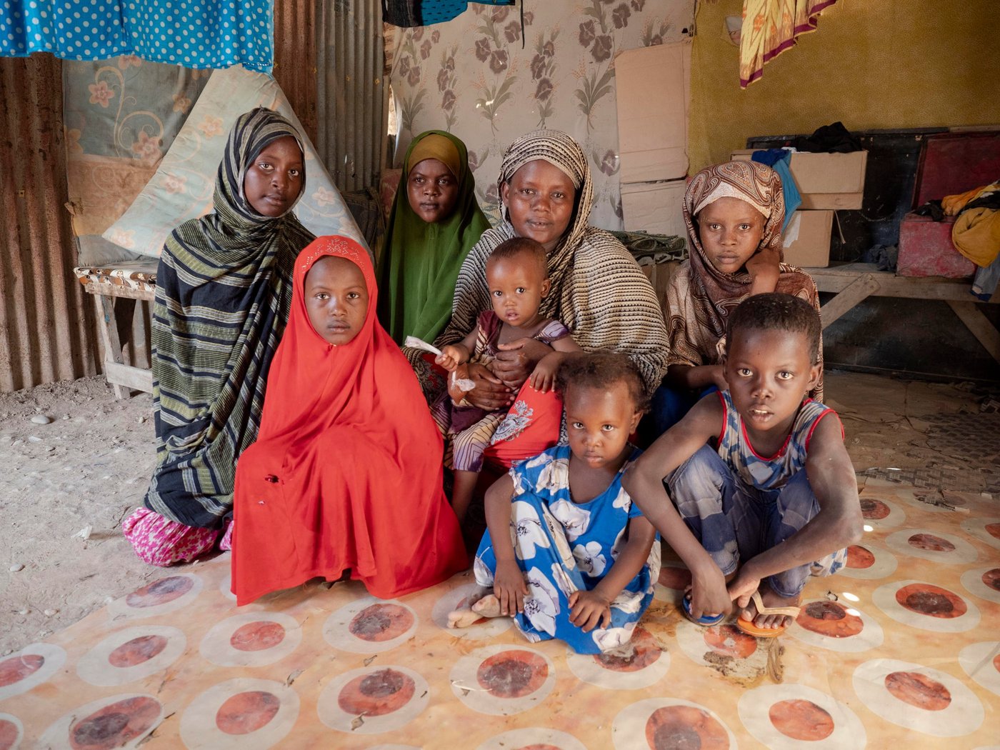 Mariam Farah Hussein, 40, fled from Mogadishu to Bosaso with her husband and seven children a week ago because of violence. They left when their neighbourhood was hit by shelling and managed to escape shortly before their own house was hit and destroyed completely.

The family had friends that had already fled to Bosaso and recommended they do the same. The journey was hard, especially for the children. They travelled for two weeks. In Bosaso they were lucky to be able to share borrow shelter in the camp from their friends. Mariam wants her children to go to school, but has been unable to enrol them as they don't have uniforms. She intends to do everything she can to afford to ensure her children can access education. 

Mariam is currently earning some money working as a cleaner, but it is difficult to get enough work. Her husband has not been able to find a job.

“I lived in constant fear. There were a lot of explosions every day. People were killed every day, murdered – anything could happen. But no-one from my family was killed. Because of this fear we decided to flee.”

“I don’t have school uniforms for my children. If we get support, I want to send my children to school. If we don’t get support, I will pay for them one by one when I have the money.

“When I was there [Mogadishu], I was very afraid. But now I feel safe. Being here is better than there.

“We have seen a lot of problems. When I left my home, it was hit by bombs. I suffered when I was travelling. After I arrived here, I forgot all my problems and fears. I feel safe.”

Children:
Fartuun Abdikadir Mohamed – 15 (green)
Muna Abdikadir Mohamed – 14 (blue/green)
Jijo Abdikadir Mohamed – 13 (brown)
Run Abdikadir Mohamed – 10 (red)
Hassan Abdikadir Mohamed – 9
Zam Zam Abdikadir Mohamed – 3

Photo: Ingrid Prestetun/NRC