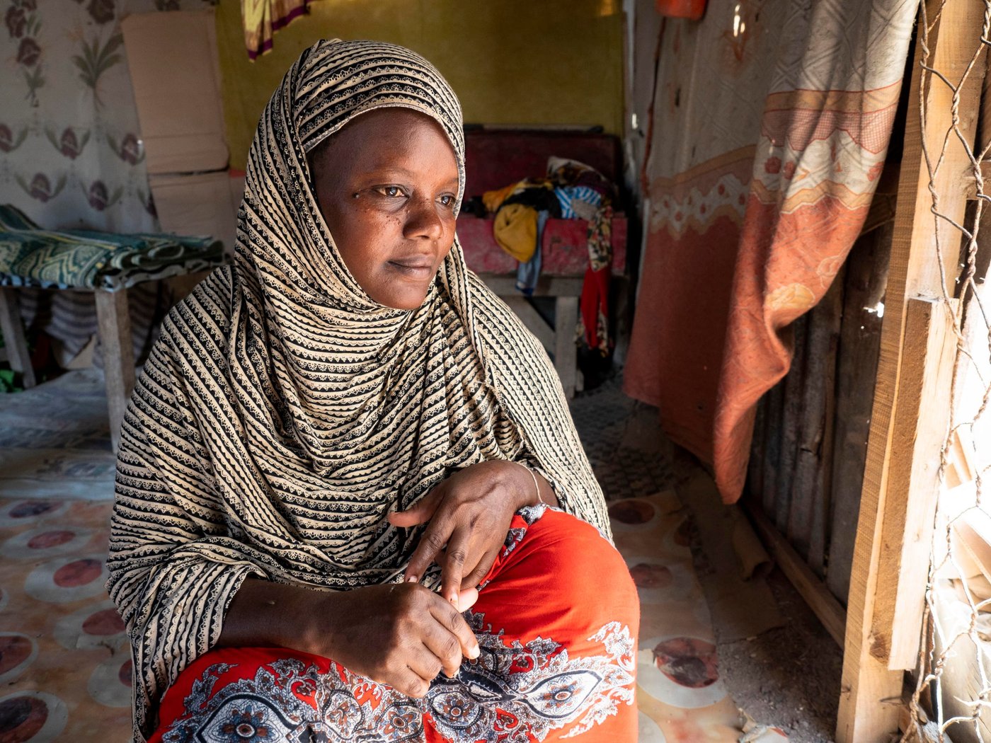 Mariam Farah Hussein, 40, fled from Mogadishu to Bosaso with her husband and seven children a week ago because of violence. They left when their neighbourhood was hit by shelling and managed to escape shortly before their own house was hit and destroyed completely.

The family had friends that had already fled to Bosaso and recommended they do the same. The journey was hard, especially for the children. They travelled for two weeks. In Bosaso they were lucky to be able to share borrow shelter in the camp from their friends. Mariam wants her children to go to school, but has been unable to enrol them as they don't have uniforms. She intends to do everything she can to afford to ensure her children can access education. 

Mariam is currently earning some money working as a cleaner, but it is difficult to get enough work. Her husband has not been able to find a job.

“I lived in constant fear. There were a lot of explosions every day. People were killed every day, murdered – anything could happen. But no-one from my family was killed. Because of this fear we decided to flee.”

“I don’t have school uniforms for my children. If we get support, I want to send my children to school. If we don’t get support, I will pay for them one by one when I have the money.

“When I was there [Mogadishu], I was very afraid. But now I feel safe. Being here is better than there.

“We have seen a lot of problems. When I left my home, it was hit by bombs. I suffered when I was travelling. After I arrived here, I forgot all my problems and fears. I feel safe.”

Children:
Fartuun Abdikadir Mohamed – 15 (green)
Muna Abdikadir Mohamed – 14 (blue/green)
Jijo Abdikadir Mohamed – 13 (brown)
Run Abdikadir Mohamed – 10 (red)
Hassan Abdikadir Mohamed – 9
Zam Zam Abdikadir Mohamed – 3

Photo: Ingrid Prestetun/NRC