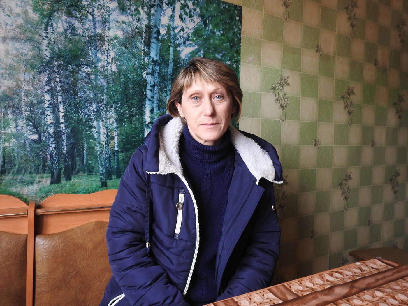 Liudmyla Benzia, 47, lives with her husband in the village of Zolotarivka, in the Luhansk region of eastern Ukraine. Before the conflict began in 2014, Liudmyla was a homemaker who enjoyed gardening, while her husband worked on a farm. 
Then, in just one day of shelling, Liudmyla and 11 other families in her village were left without a roof over their heads. Most of them have never been able to rebuild their homes, which were virtually razed to the ground.
The family survived on Liudmyla’s husband’s salary, with no-one to turn to for help.
“Six months after the destruction, the village council supported us with some small funds,” says Liudmyla. “Since this was not enough to restore our property, we bought a tiny flat in the village. We also received assistance from various humanitarian missions to meet our basic needs.”

Photo: Violetta Shemet/Norwegian Refugee Council