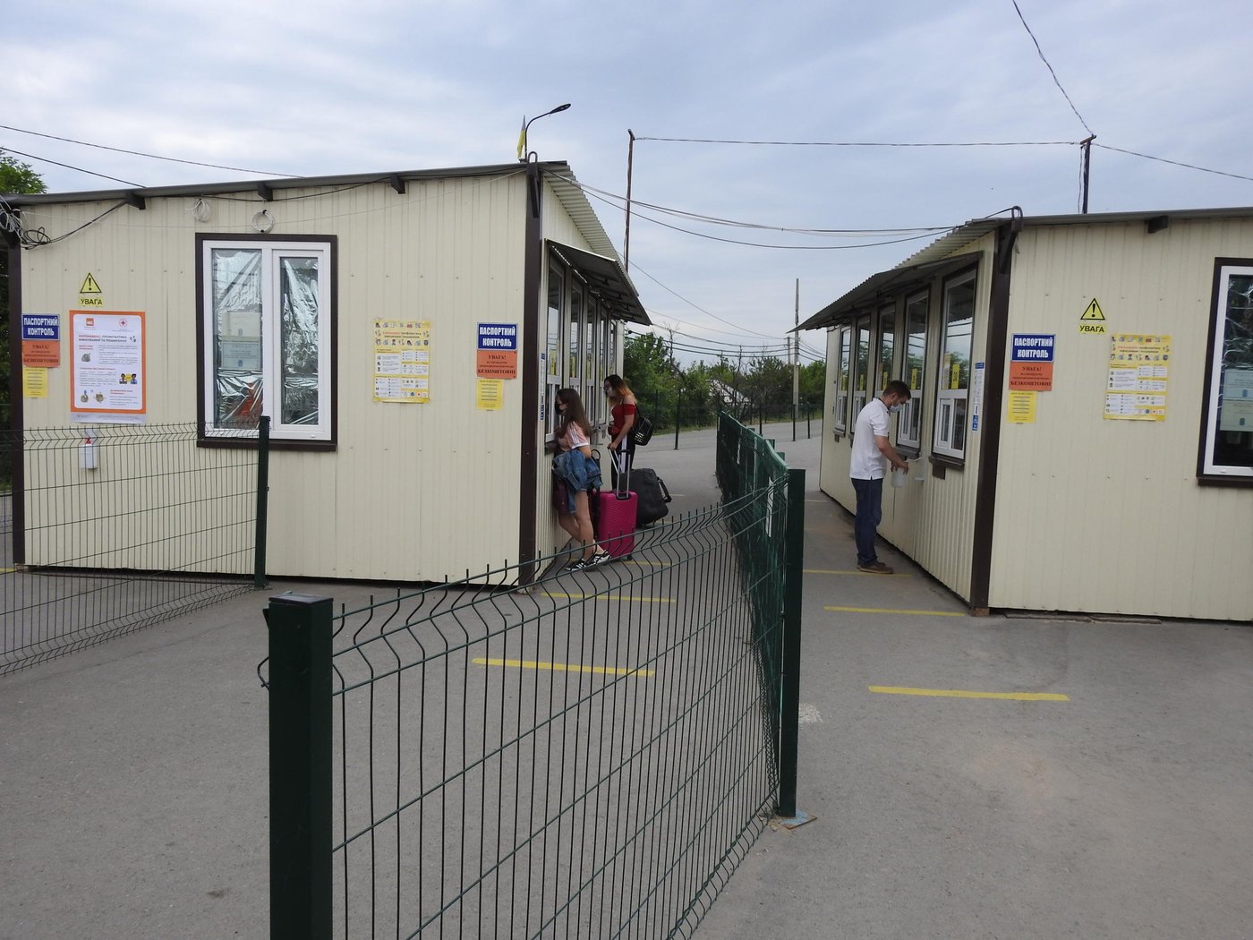 While Covid-19 restrictions have gradually been eased across Ukraine, freedom of movement across the “contact line” for half a million people living in non-government controlled areas (NGCA) remains mostly limited due to the uncoordinated re-opening of the crossing points, complicated crossing procedures, restrictions on who had permission to cross.
Civilians repeatedly became stranded in the “grey zone” being stuck and spending several days in tents surrounded by mine-contaminated fields.
Besides, people who cross are subject to self-isolation or observation in a health facility for 14 days, meaning the vast majority who seek to cross for just a few hours to receive pensions or access services are unable to do that.
Moreover, crossing points still lack essential services such as hygiene facilities, drinking water and first aid and risk turning into the cluster of infections unless sanitation and hygiene conditions are improved.
We are securing access to disinfectant means and improving sanitary there as well as providing vital information to increase people’s knowledge on how to protect themselves and prevent the spread of the virus.
Photo: Violetta Shemet/Norwegian Refugee Council