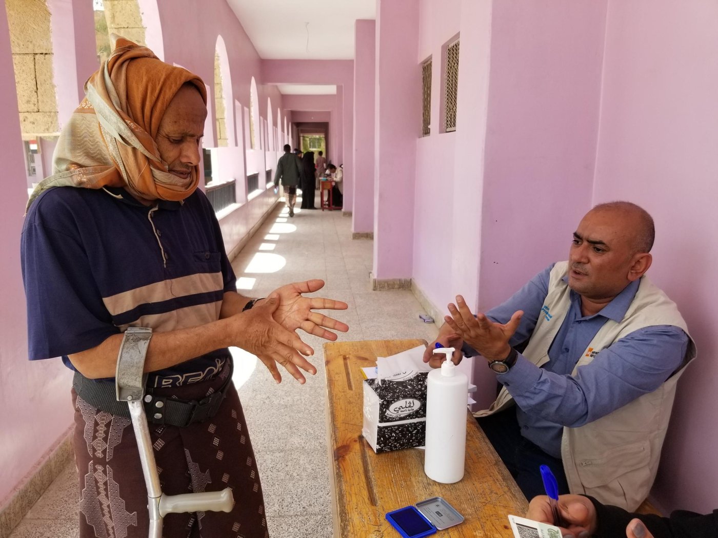 There are hand sanitizers at the main gate, and work with the committees distributing vouchers to people to ensure people sterilize their hands when they come to collect their vouchers and when they leave.

Photo: Nasser Abdulkareem/NRC