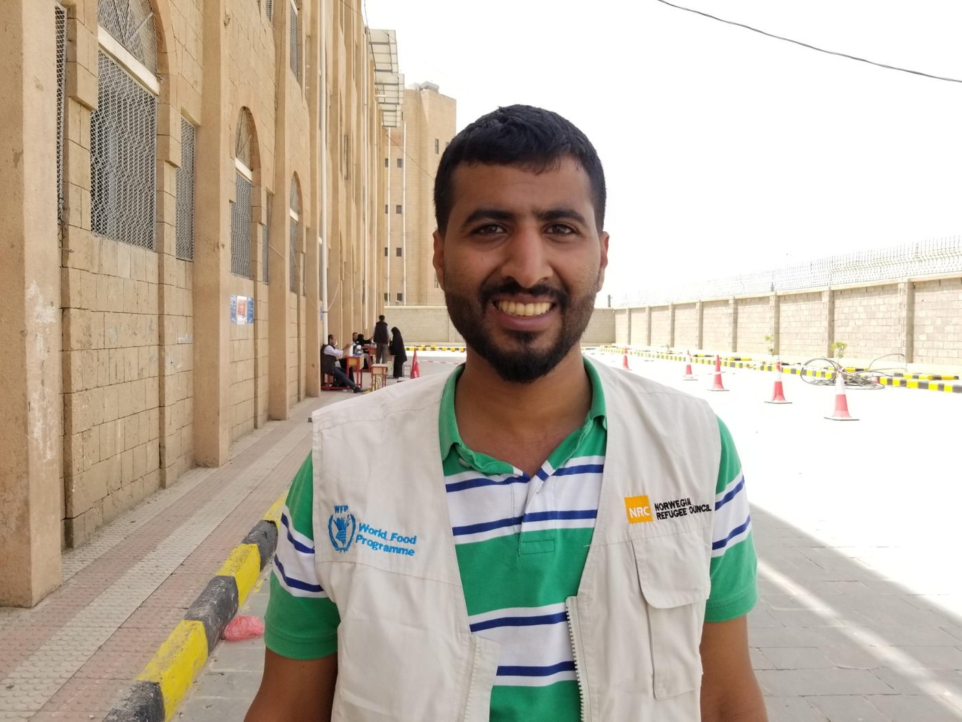 Mohammed Al-Afeef, supervises the distribution of food vouchers in Azal point for NRC in the Capital Sana’a.
“We put hand sanitizers at the main gate, and work with the committees distributing vouchers to people to ensure people sterilize their hands when they come to collect their vouchers and when they leave.
“We also ensure that there is at least one meter between people in the queues, and we divide people coming to receive vouchers in to smaller groups, and organise the distributions over several days.”
“NRC puts up posters on the walls at distribution points to raise the awareness about coronavirus and how to take precautions,” Mohammed says. “The distribution has gone well and as we planned.”
Mohammed confirmed that the conditions of beneficiaries are very difficult, stating that some families completely depend on this food aid to survive.
Photo: Nasser Abdulkareem/NRC