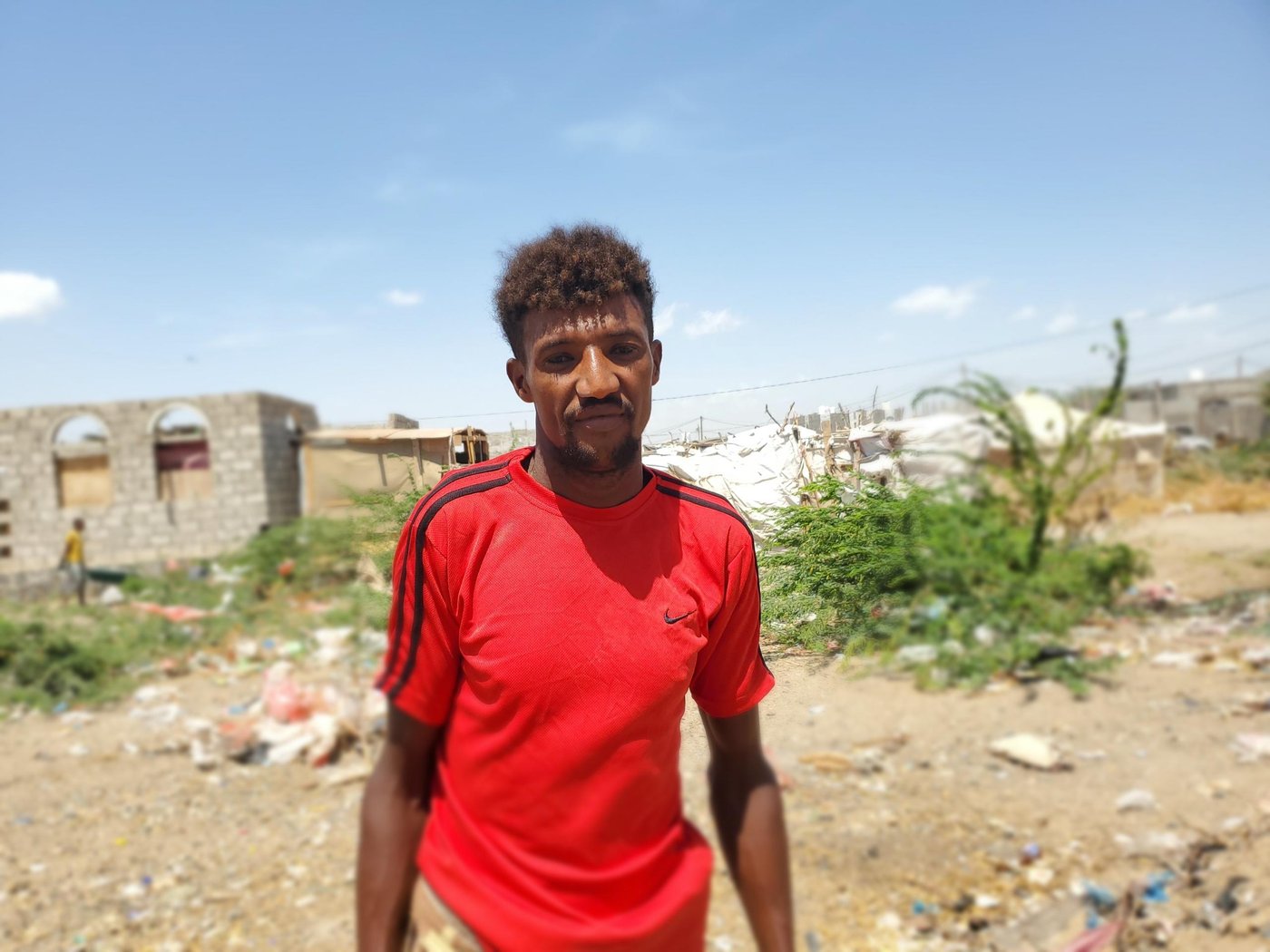 “Nothing is better than seeing my city clean.” Hisham Abdullah has been a cleaner for more than ten years, in his home city of Mocha. “I work every day from early in the morning until noon,” he says. 

He is grateful for his job with the local council, which is the only source of income for his family of seven. But it is not an easy job, as there is a lot of physical effort needed to sweep the streets and heft heavy rubbish bags. And at times it is made harder by the attitudes of Hisham’s fellow residents.
 
“Sometimes we can face insulting remarks from people,” he admits.
Perhaps for this reason, Hisham has always appreciated those who have been supportive of his work, helping to clean outside their houses and shops. “When the community joins us in a cleaning campaign,” he explains, “it encourages us to work harder.”

But recently, Hisham has been aware of a shift in attitudes. Because on 10 April 2020, Yemen confirmed its first case of the novel coronavirus: Covid-19.

Before the conflict, Mocha was a small coastal city, known for its fishing—and also long ago as a major coffee port, after which the café mocha is named. But in the last three years it has become a destination for thousands of displaced families seeking safety from the conflict. This influx of people has meant an increased need for cleaning teams like Hisham’s.

 “We clean all camps in the city and around it,” Hisham explains. “The displaced people appreciate our work, to be honest. Most of them collect their rubbish in plastic bags and put them in the in front of their tents.”
 
Not everyone was so supportive. But since Covid-19 has hit Yemen, people are taking cleaning more seriously. Even those who had previously been uncooperative now see hygiene as a priority.
 
“Everyone started to respect us and help us in cleaning their neighbourhoods,” Hisham says.

In the wake of the first confirmed case, Hisham’s team is one of many being supported by the Norwegian Refugee Council (NRC) to step up their efforts to keep local markets and camps clean. This is part of a range of new measures NRC has rolled out to help combat the virus.
 
“Cleaning is not a new thing for us, we have been doing it for years,” Hisham says. “But the NRC training showed us how to work safely so we won’t be affected by the coronavirus or help spread it.”
 
Hisham was particularly glad of the protective equipment that came with the training. “NRC provided us with gloves, face masks and cleaning tools.”
 
 “The happiest day for me,” Hisham says, “is when I see that Mocha is clean, and people are helpful and aware about the importance of cleaning.”
 
Photo: Zaid Al-Haimi/NRC