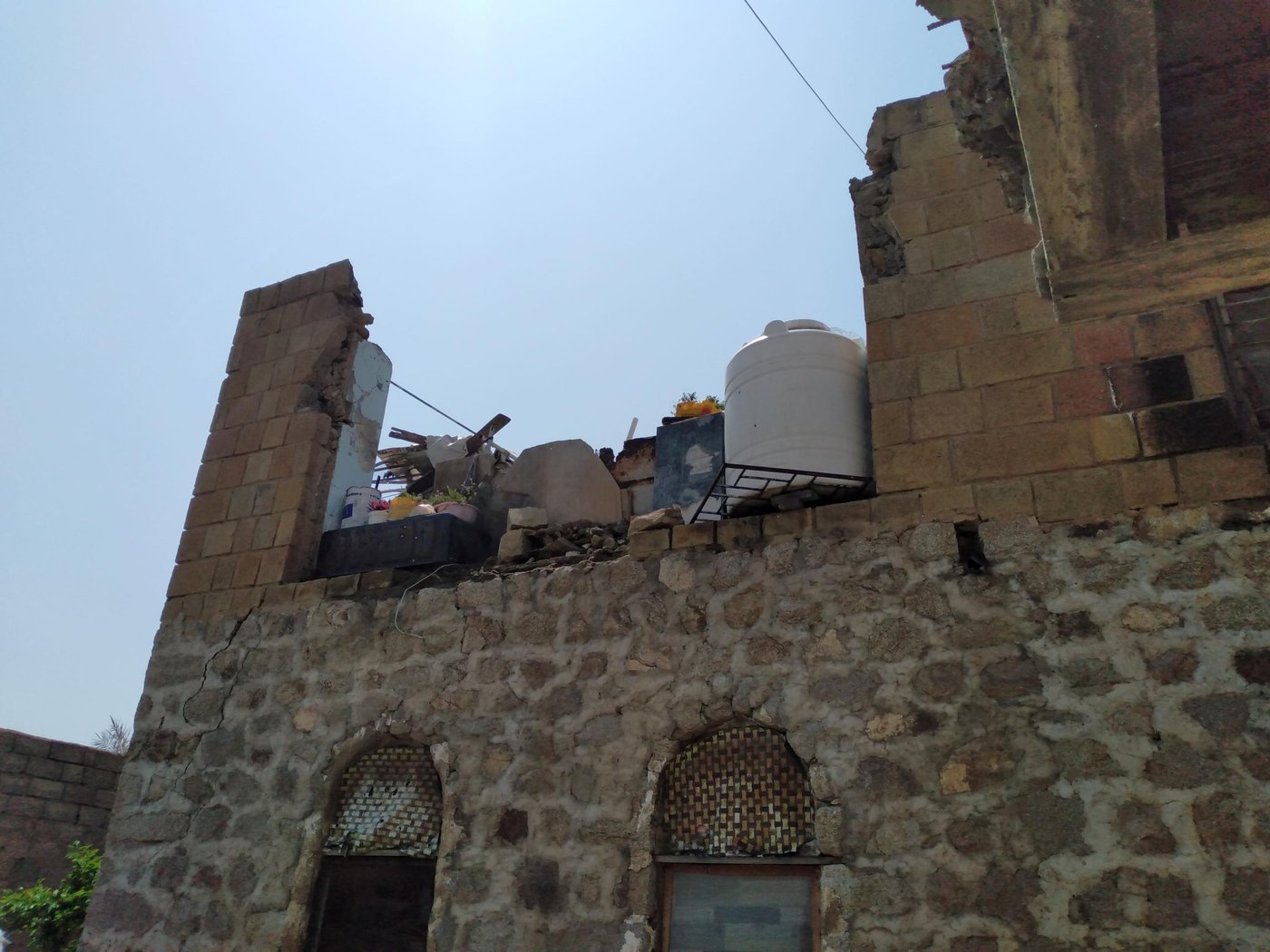 Picture of Sameer's home that shows a destroyed second floor.