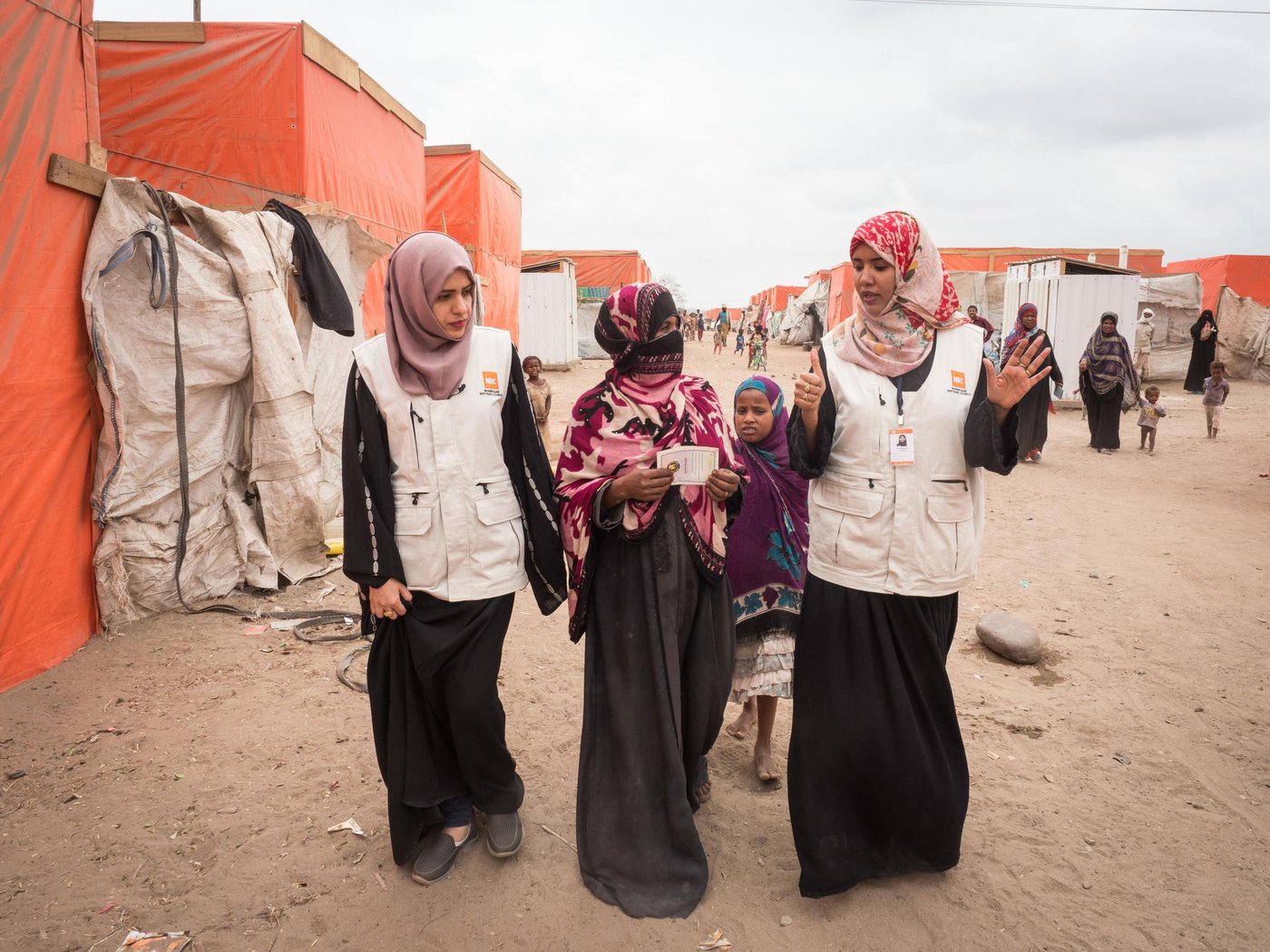 Ruaa Mohammed, Information Counselling Legal Assistance (ICLA) Assistant, and Nuhad Mubarak, ICLA Officer, are explaining child birth certificates to Nour, whose son Hamza received his that day.

Al-Mishqafa camp was established in late 2016 and initially hosted 60 displaced households (approximately 420 people). By 2018 the number of the households increased to 300 (2,100 people), at which time NRC, with funding from UNHCR, began providing cash assistance via its Information Counselling Legal Advice and Protection Programmes. The program further supported displaced families with IDs, supplying 88 people with ID cards, and 165 children with birth certificates. 

In November 2018, NRC’s shelter department built 312 shelters and 120 latrines. The camp population is still in need of continuous support as they lack consistent access to food and safe water, and struggle daily with camp conditions that expose them to insects, snakes, scorpions and very windy, dry weather during the summer season.

Photo: NRC