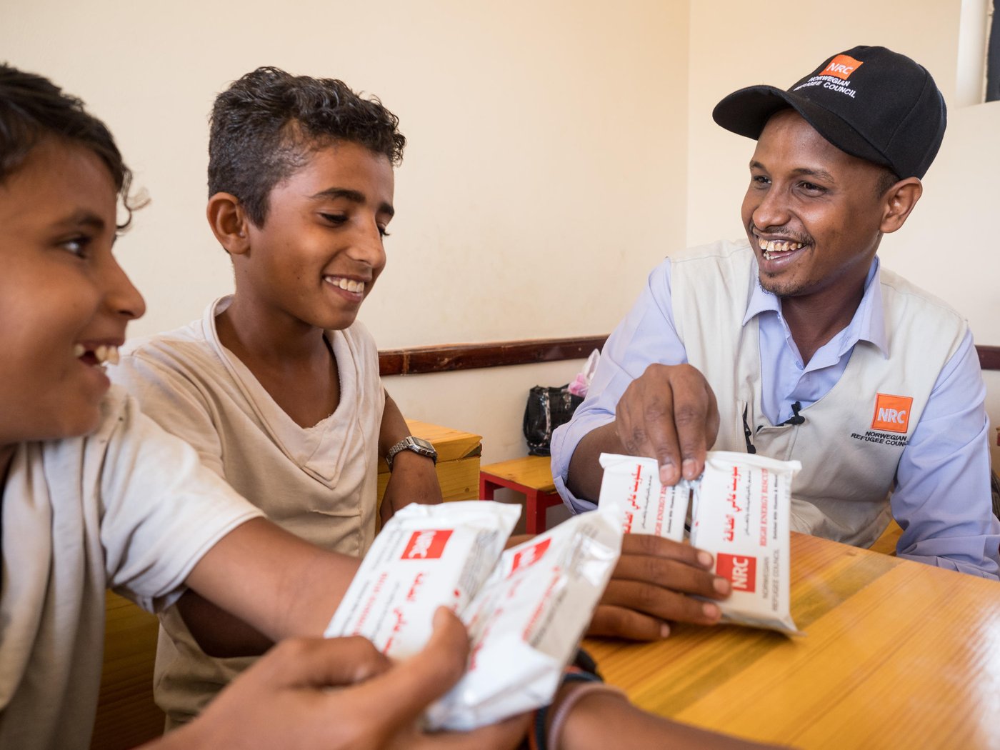 NRC staff distributing high energy bars to school children in Yemen.
