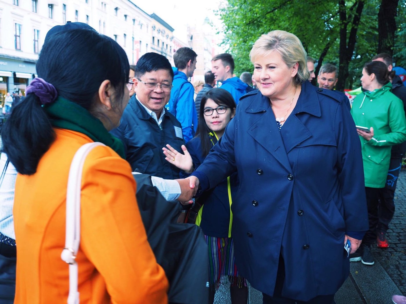 Delegates from Myanmar shake hands with Norway's Prime Minister, Erna Solberg on Karl Johans Gate. 