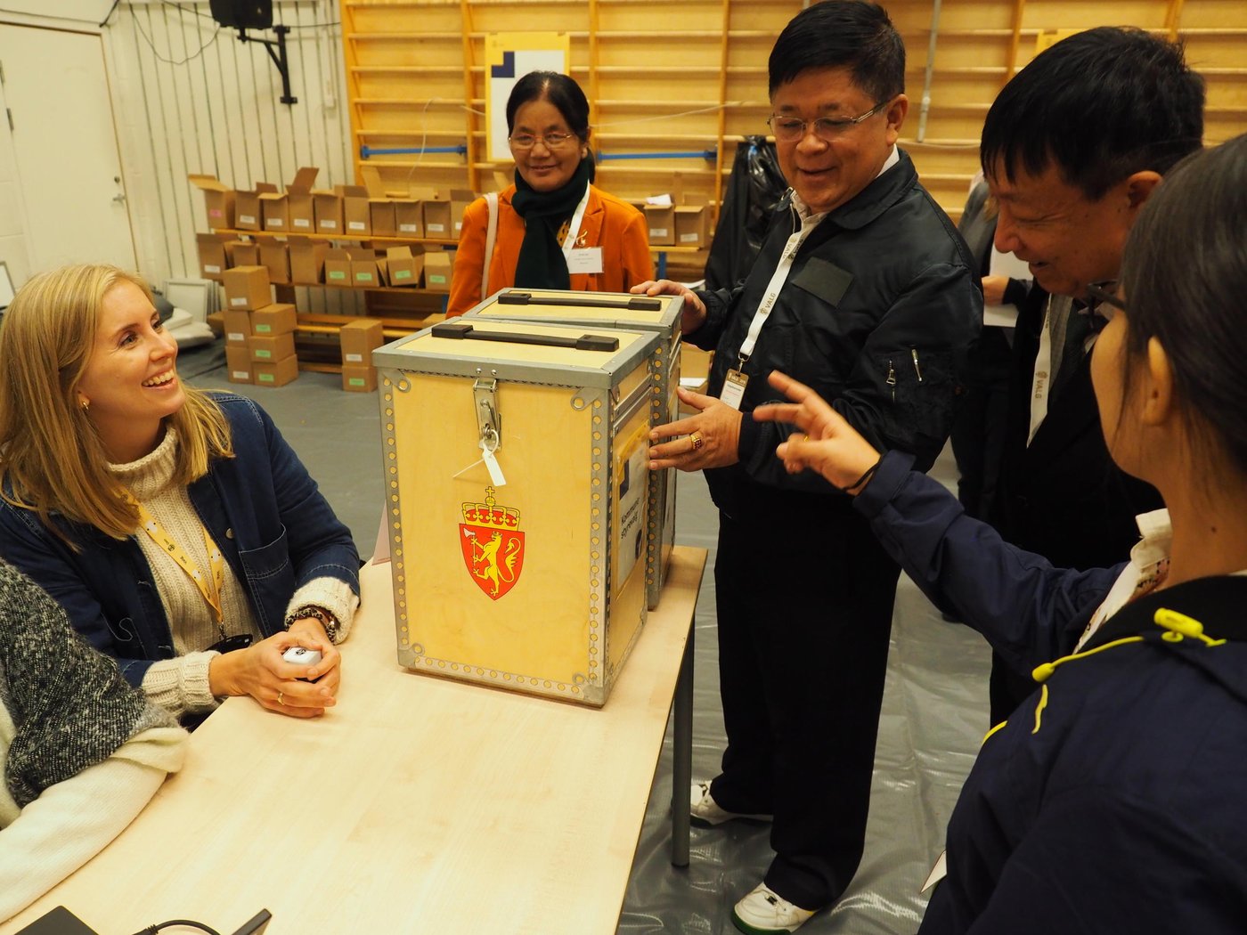 Delegates from Myanmar inspecting Norwegian ballot boxes at a local polling station in Oslo
