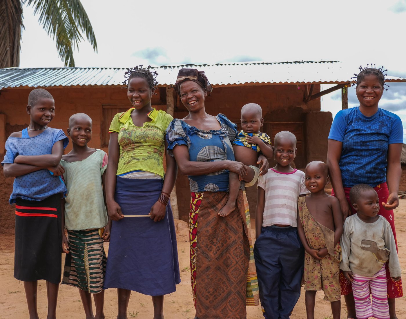 Monique Kanku Luboya, 45, stands in front of her new house with her children (from youngest to oldest) Bambi Angel, 2; Sylvain, 4; Elyse, 6; Mopero, 8; Monique Kapinga,10; Berthine, 12; Marie, 18; and Agnes, 20.
Photo: Itunu Kuku/NRC