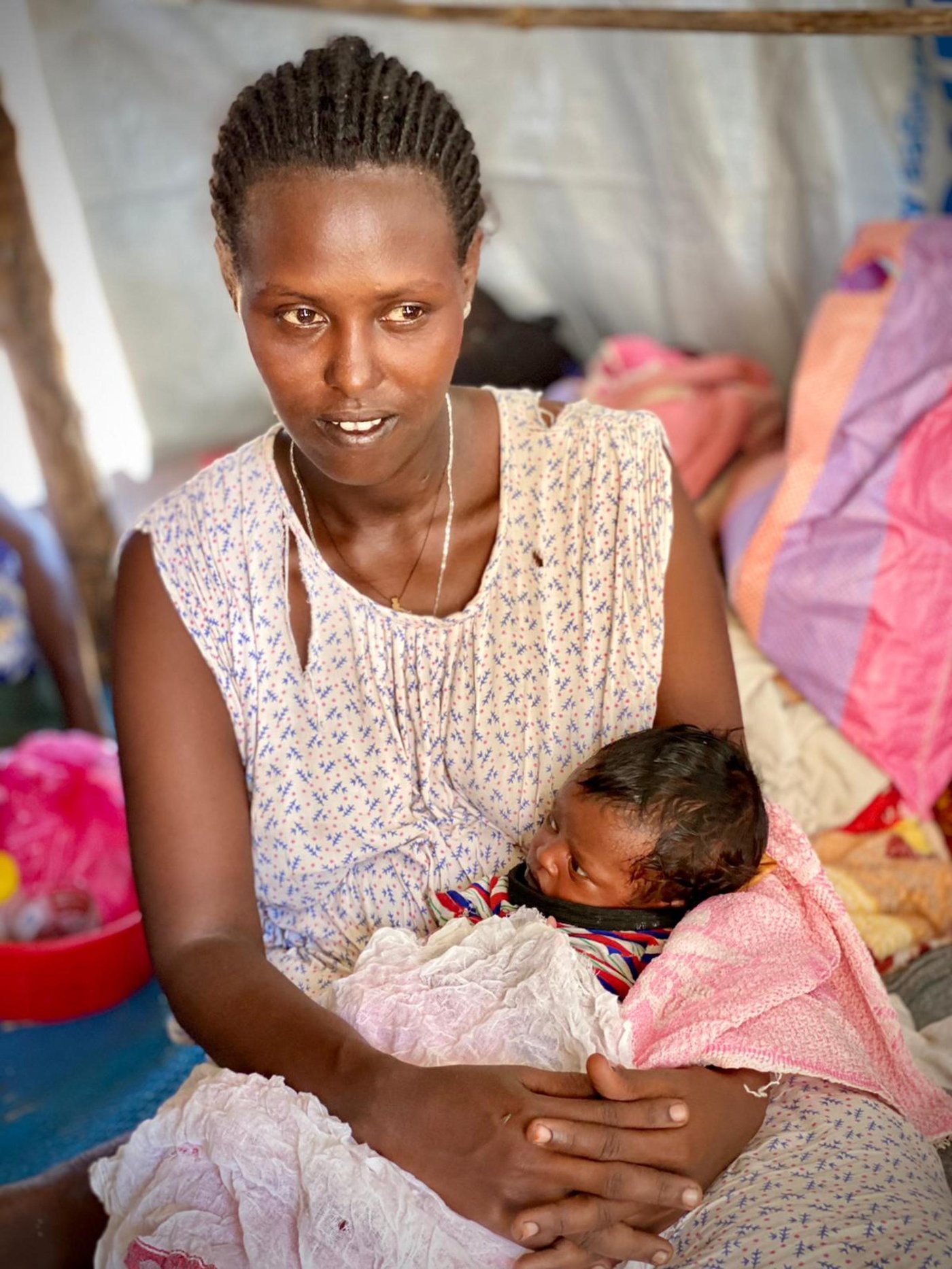 Tirhaz, 25, was actually born in Um Rakuba camp, when her parents came there during the famine almost twenty years ago. They left the camp, and her father collected and transported water for a living. When he died, her family faced many problems. She had one seven year-old son, who was with her cousin. When the fighting broke out, she was heavily pregnant. She gave birth on the way to the border crossing. Other women passing by helped tend to her, as she gave birth to her second son. He sleeps next to her in the communal refugee tent. She has barely enough milk to feed him.
Photo Credit: Will Carter/NRC