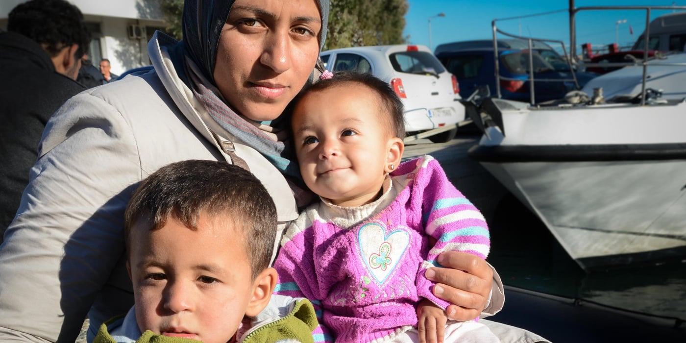 Syrian Lemia and her children Omar Mohammed (3) and Lojen (1) have arrived the port in Chios, Greece – after a tough journey across the sea from Turkey. Photo: Tiril Skarstein, NRC

Cuts in the support

Name: Lemia
From: Deir ez-Zor, Syria

“We fled from Syria because of the war. We had nothing there anymore. Our home was bombed into rubble”, says Lemia.

Three years ago she and her family arrived in Turkey, close to the border with Syria. 

“When we first arrived it was good. We were safe there and received enough support to get by. But then the assistance was cut. The last year and a half we have been suffering”, the Kurdish woman explains.
 
She is three months pregnant, and is making the dangerous journey towards Europe together with her husband and two children. The parents hope to be able to offer their children safety, necessary medical support and an education. 

“I wish for my children to be safe. I don´t want anything else”, Lemia says.