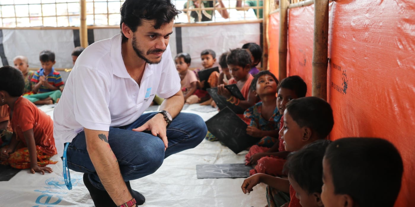 Henry Renna Gallano, education in emergencies expert, with Rohingya refugee children in a learning centre in the refugee camps in Cox's Bazar, Bangladesh. (Photo: Ingrid Prestetun/NRC)