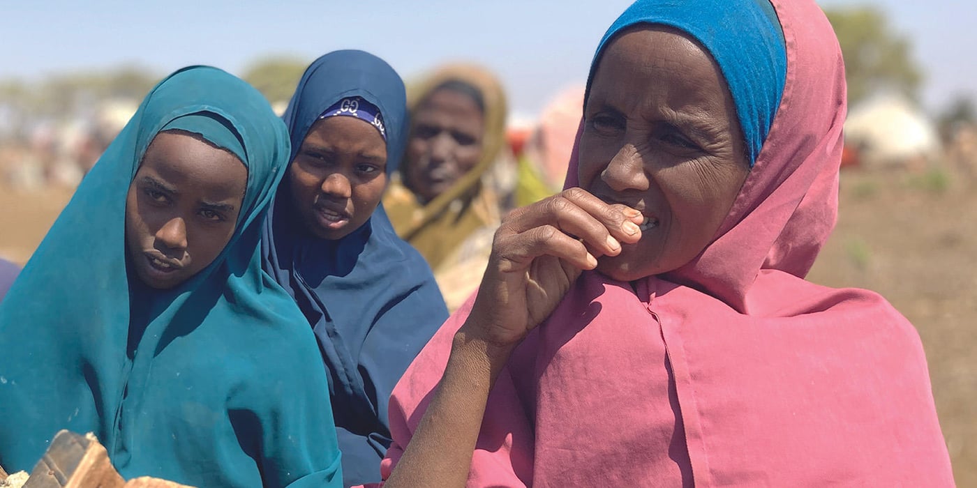 Three women are standing in line.