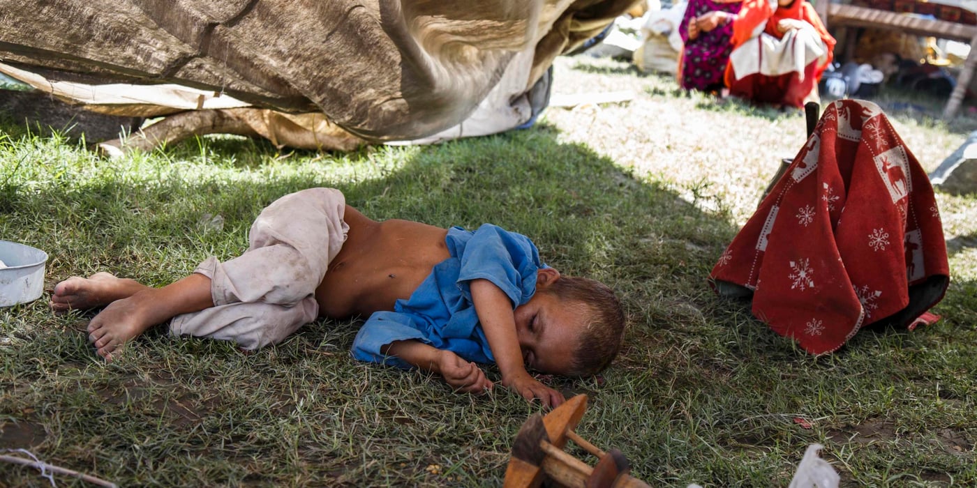 This boy is exhausted and malnourished after his family felt forced to flee their lives as refugees in Pakistan and return to Afghanistan. He lies underneath a half-collapsed, aging tent. (Photo: NRC/Jim Huylebroek)