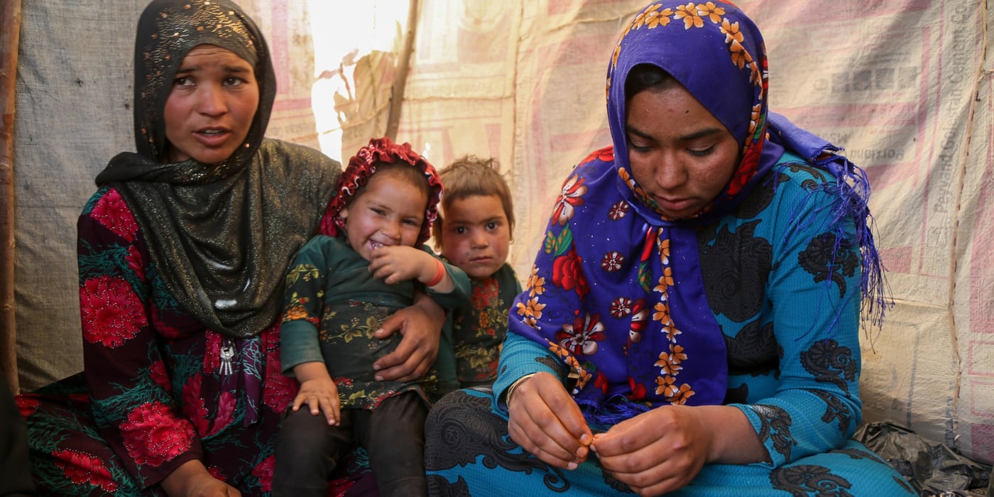 Sultana, 24, (right in blue) and Hajira, 32, (left in dotted red)

 Sultana lost her three months daughter due to cold in one of the IDP settlement in Badghis, Afghanistan. The family have forced to come from Kharistan area to Qala-e-naw city due to sever drought some two months ago. 

"My little was fine before we left the village. We came here and slept in the open with only a tarpaulin over our head. My daughter got pneumonia at the beginning and latter she died," said her mother grieving.

"She cries all the day and often comes here to talk to me and forget about her daughter," Hajira mother of five said.

"She lost her daughter due to cold and it made me worried not losing my children," she adds. 

Hajira has five children and also a seven months pregnant. She asks for immediate shelter and winterization assistance as winter is looming. 

"We can't go back to our home because we can't find even a drop water as all wells and water sources have dried up," she said when we asked if they are planning to go back. Though the family do not have proper shelter in Sanjetak settlement, but they have been provided with water tracking and water tanks. 
PHoto: NRC/Enayatullah Azad