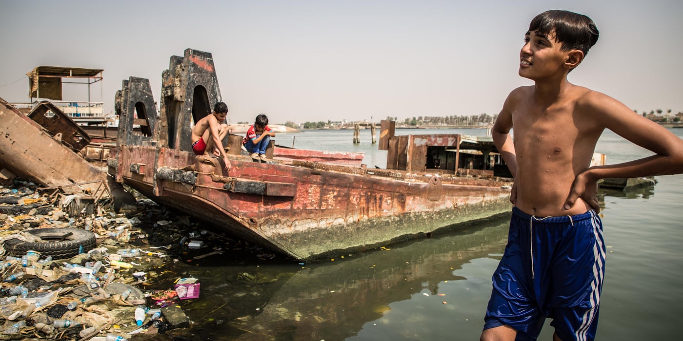 The youth enjoy swimming and fishing in Basra's main river. Entire groups spend their time by the river, having fun in the middle of waste and rusty shipwrecks.

Khalid says, "We all know someone who is sick because of the water, but what can we do? There is no clean water in the city, we have no options."

Photo: Tom Peyre-Costa/NRC