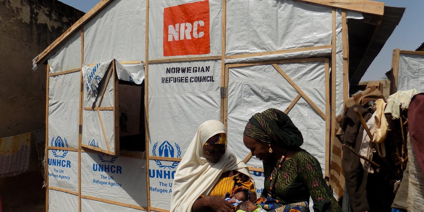 “I hope for a better future for my children, but for now we need assistance to stay alive,” says Halima (Her name is changed for privacy reasons).
She is one of more than 43,000 internally displaced people and people of host communities in Maiduguri receiving assistance from Norwegian Refugee Council (NRC).
2.2 million people displaced
Nigeria is one of the main countries that continue to be affected by violence in the larger Lake Chad Basin. The violence caused by Boko Haram in 2009 has left an estimated 2.2 million people displaced. Homes and livelihoods have been destroyed and many households are struggling to survive under desperate conditions.
Amidst the many dire and tragic stories, however, a little joy can be found. in 2015, Halima and her husband escaped the massacre caused by insurgents in Baga. Together with their three children aged 11, 6 and 3, they walked almost 230 km to seek safety in Maiduguri, northeast Nigeria. On arrival, the family found shelter in a primary school classroom, sharing little space with 20 other displaced people who had all fled from violence. Shortly after, the family was registered by NRC and on 31 July 2016 they received a shelter.
Just in time
The shelter came just in time, with Halima giving birth to twin girls in their new home just two days later. When looking at her babies, she smiles.
“There was no time to get to a hospital, everything was going very fast”. Despite the stress of displacement and illness, Halima is relieved her babies were born healthy.
While still adjusting to life in Maiduguri, she says “NRC assistance made a difference. Life is difficult but at least our family has a place to live.”
A proud mother of five children, she fears for their future. Her husband used to be a fisherman and now generates some income as a tailor. Her children do not go to school and her family misses the life they had before they were displaced.
Following shelter assistance, Halima’s family will receive non-food items such as soap, laundry detergent, a bucket and a mosquito net. Her newborns will be assisted by the legal assistance team with birth certificates, which are required to obtain national identity documents and facilitate access to services such as education and health care. Plans are also underway to establish a borehole in the community, which provides access to safe drinking water.
Foto: NRC/ ROSALYN VELDS