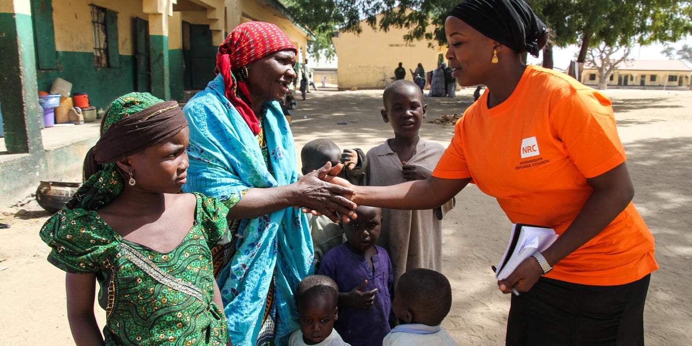 Munakur(right) saying good bye to Mairamu and her grandchildren after an interview in a shool where they in Galtimari.
Many displaced families have occupied schools in Maiduguri and are living in congested classrooms because they have no better place to go to.
Mairamu is an 85-year-old widow from Bama local government area. She has been living in the school with her son and 11 grandchildren for almost 2 years now.
Back home, she sold firewood and bread and her two sons were farmers. Life was good and she could eat whatever she wanted. She fled from her home in Bama, after heavy fighting where many people including one of her sons were killed. Now she begs in the streets in order to buy food and often she is forced to sleep hungry.
Mariamu’s wish is for peace to be restored in order for her to go back to her home and that her grandchildren would be educated.
Some of her quotes:
“running without eating and drinking, we came to Maiduguri”
“We were afraid if we stay we will be killed that is why we fled, we were afraid, we fled and came to Maiduguri”
“My wish is food, wrappers and everything, we also want sleeping materials, body lotion , we are together with children and there is sickness”
“I wish that my grandchildren will be educated, I wish they will be educated”
Photo: NRC/Ingrid Prestetun