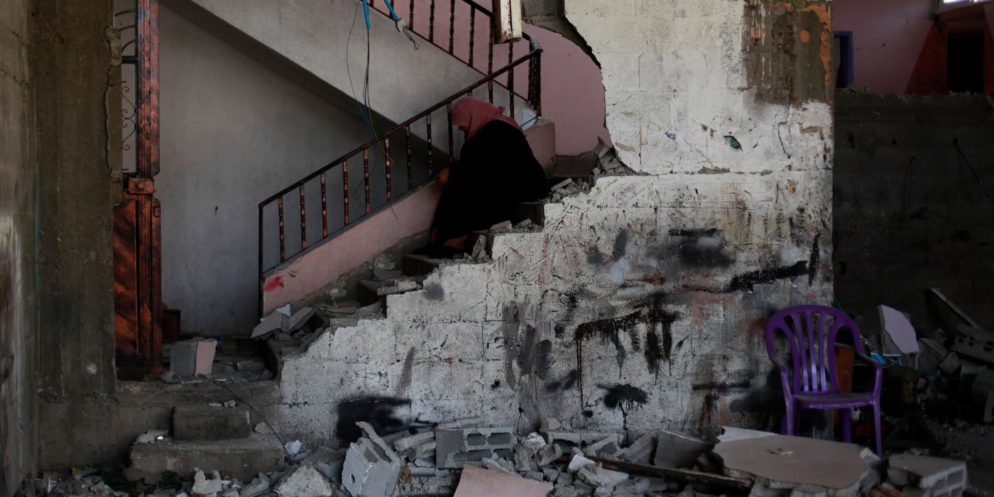A woman crying after seeing that her house and neighborhood were destroyed. Al Shajaeyah area, Gaza, 1 August 2014. photo credit: Emad Badwan