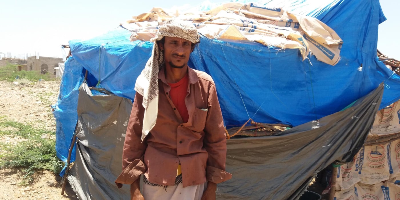 Despite hearing of other families feeling, Ali had not thought it would happen to him. But only two weeks ago, early on 6 May, airstrikes hit his extended family on the farm where they worked.

Just like his father before him, Ali Ibrahim had spent most of his life as a farm labourer, in his home village of Al-Jar. 
 
It was hard work but peaceful, planting vegetables like tomatoes, onion and garlic. Most of Ali’s extended family worked alongside him on the same farm. Though his income was only YR1,000 (less than two dollars) a day, it was enough to support his own family of seven children.
 
“My brothers and I have been working on the farm for 15 years. We built oshas (straw huts) on the farm and we lived there, as we spent most of our time on the farm,” Ali says.

The war first intruded on them in 2015, when the price of fuel doubled, forcing the farmer Ali worked to stop all work for some months. Ali was also aware that families from other areas were fleeing their homes, but didn’t think it would happen to him.
 
“During the last few months, many families from neighboring areas fled their homes towards Al-Shaqaf village, after battles reached their area. But our area was safe.”

This changed one evening. On Wednesday 6 May, warplanes started to fly over Ali’s village. He and his family didn’t sleep that night, listening to it.
 
It was morning when the first bombs fell. From less than a hundred metres away, Ali saw his cousin’s hut hit.
 
“My cousin tried to flee the farm with his family, but an airstrike hit them… Three were killed, including a few-months-old child. And four others were badly injured.”

Other strikes followed. “Eight airstrikes hit the village and the farm in few hours, and almost all residents of the village fled their houses.”

In the ensuing chaos, Ali tried to help the injured. “We saw the deaths in front of us. I took my children and the injured people to Al-Jar clinic.” Then he fled with his family to nearby Al-Shaqaf, with only the clothes they were wearing.

“We didn’t take anything with us as we left on foot. Even the dead bodies we didn’t take. Some brave people returned the second day to bury them…. It would have been death and nothing is better than life.”

Cattle were also hit by the airstrikes. No one dared to stay. 
Ali’s children were witnesses to the burnt bodies of their friends and relatives. Some cried, while others were too shocked. They have difficult sleeping now. 

“No one can believe what happened for us and we didn’t imagine it before. I met many displaced families but I wasn’t aware they witnessed such atrocious moments.”

When his family arrived in Al-Shaqaf, they found other displaced families living in tents made of plastic sheets and wood. “As soon as we arrived here, a new journey of suffering started as we don’t have money and we don’t have furniture. But we are lucky that the displaced people [already] here welcomed us.”

Ali’s family now live inside the tent of another family, who fled their house last year. Despite being in dire circumstances themselves, this family shares food, water and everything they have with Ali, who has no money to even buy a plastic sheet to set up a new tent.

“We are in need of everything, but shelter and food is priority as we don’t want to stay in others’ tents for a long time.”
Ali doesn’t know anything about the unilateral ceasefire, nor about Covid-19 and what kind of danger it represents for displaced people.
 
“I’m illiterate man and all I know is that warplanes targeted us and forced us to leave our houses, and we lost our source of incomes in this holy month,” he added.
 
Ali hopes that he can return his village and resume his work but he feels that is impossible now. 
“The best thing was when we would wake up early in the morning and water the vegetables. And after an hour all the farmers would sit together to have their group breakfast in the farm. Those days can’t come again, as some of my relatives and colleague were killed by the airstrikes.”
 
He wanted to send a message to the whole world about his situation: “There is nothing worse than seeing relatives became burnt bodies and hearing the screaming of children all the time, so try to imagine yourselves in our situation and stop the war on us.”

Photo: Anwar Abdu/NRC