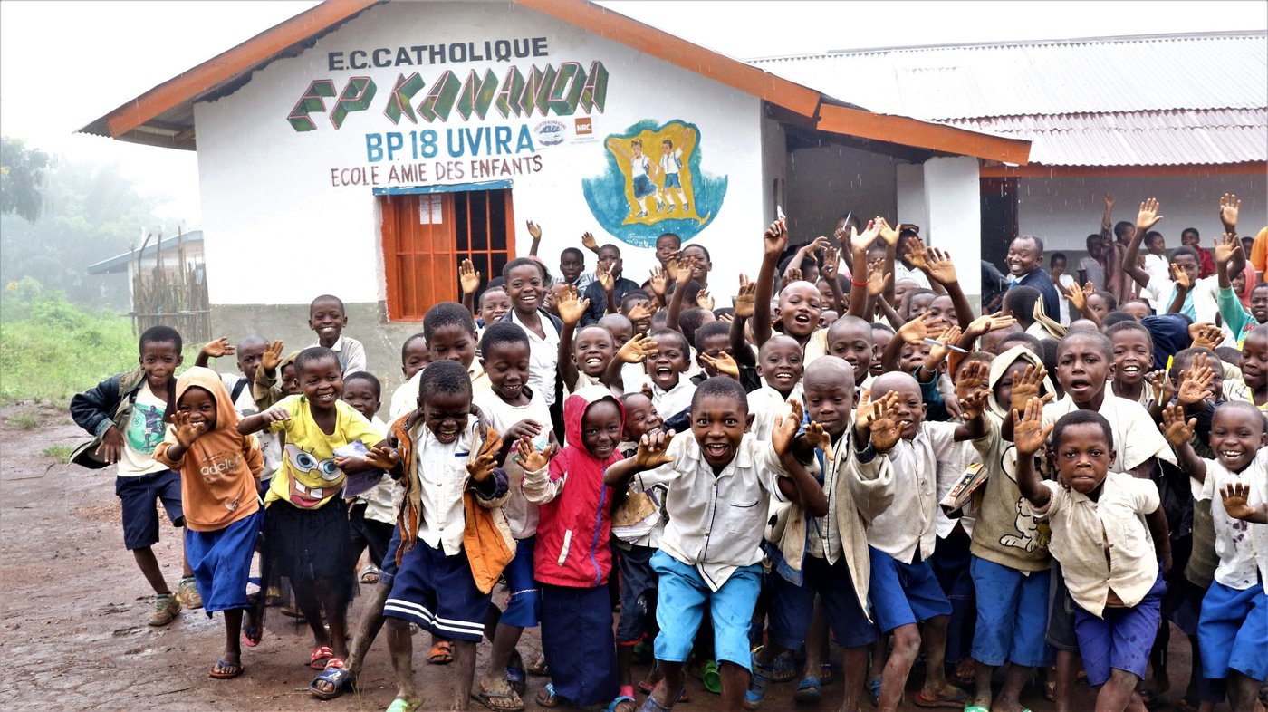 It is 10: 30 am, the recreation time at Kananda primary school in Fizi territory. It is raining, cloudy and cold but the rain cannot stop students and teachers to rejoice: singing and dancing as part of their recreation time.

Kananda Primary School is just one of 32 schools rehabilitated by NRC in South Kivu province. Due to roof damage from bullets, when it rained, students would have to suspend classes, as the inside of their classrooms would begin to flood. In addition, the sanitation infrastructure in the school and throughout the village was dilapidated or non-existent. Students were risking both their safety and health by using the crudely constructed latrines. Being that the latrines were uncovered, students were vulnerable to infections and water-borne diseases.

With Education Cannot Wait donor support, NRC has patched the damaged roof to ensure that classrooms, students and materials remain dry when it rains. Metallic doors and window frames were provided, and the school was repainted. Latrines were rebuilt and covered for conditions that are more sanitary. The learning environment has greatly improved and the number of enrolled students has increased from 240 students in 2018 to 340 students in April 2019.

To implement the Education Cannot Wait-funded project, NRC has collaborated with Danish Church Aid (DCA) and two national NGOs, Collectif ALPHA UJUVI and Caritas to rebuild destroyed schools, restore proper sanitation and water points in schools. NRC has provided notebooks, pens, pencils and other school materials to children and has trained teachers on psychosocial support. In addition, we paid the final examination fees for students in sixth grade and trained teachers on psychosocial support, Risk Reduction Plans and Training of Parent-Teacher Associations on Good Governance in Schools. 
In total, NRC education support has reached 14,000 of children whom the majority are displaced, returnee and destitute children from the community in South Kivu province.

This assistance, however, is only a drop in the ocean, seen the huge needs which are still uncovered in the province and the country. We need further efforts in term of funding so that we continue rebuilding destroyed schools; organise catch-up classes to help many children out of school to get access to quality education in a safe and protected environment.

April 26, 2019
Photo: Ephrem Chiruza/NRC