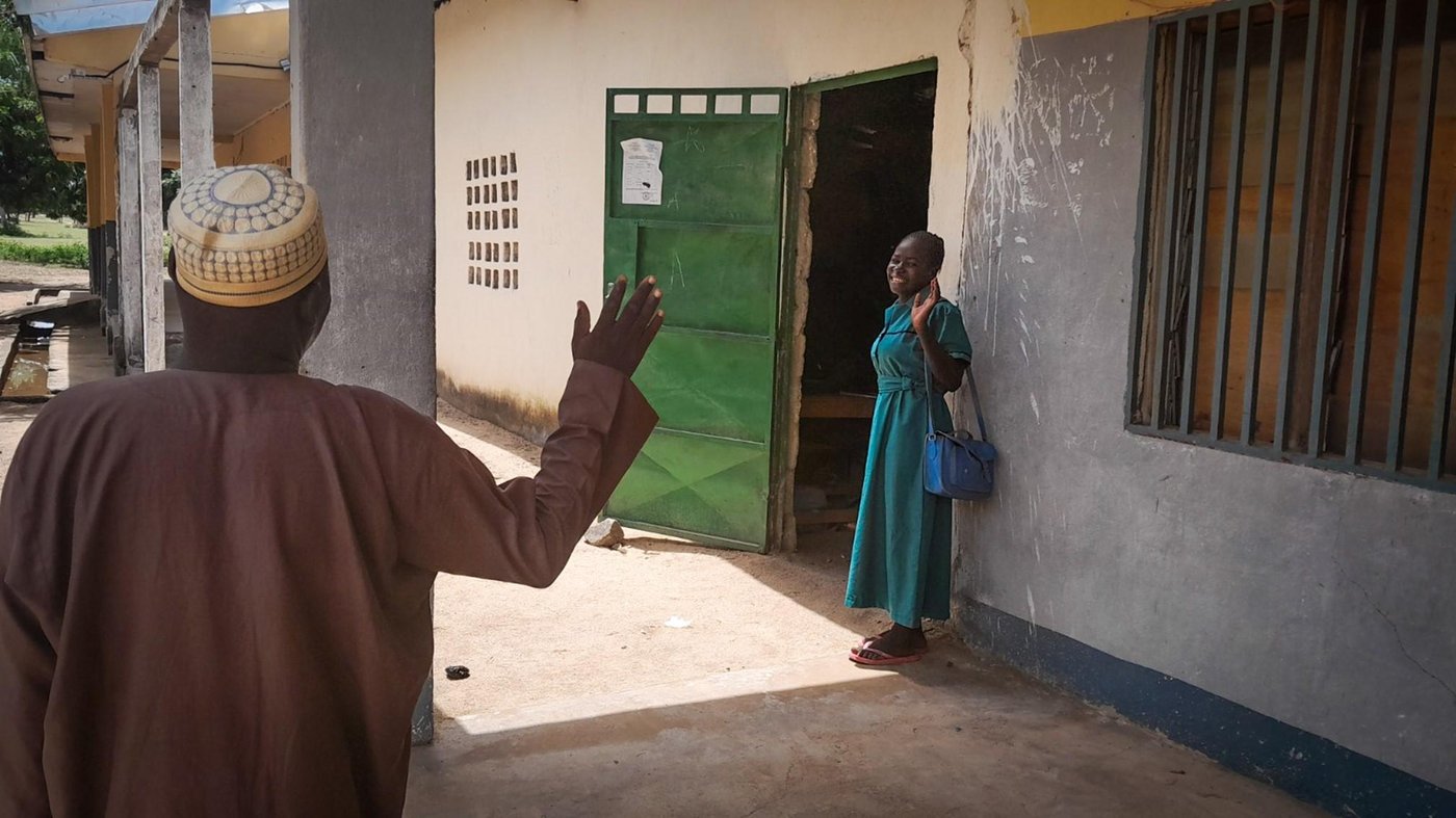 Fadimatou waving to her father on her first day in high school.