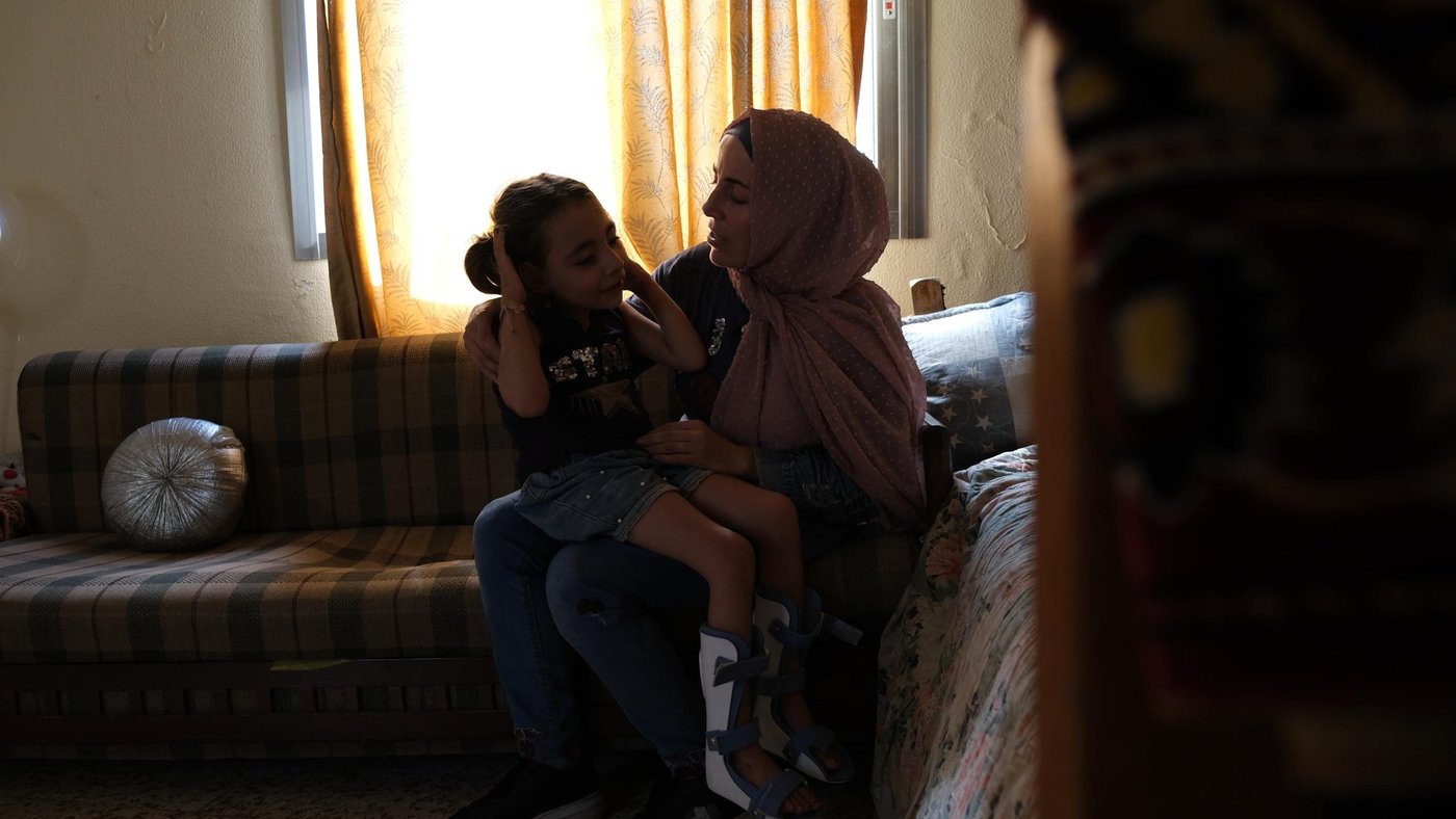 Woman with her daughter on her lap.