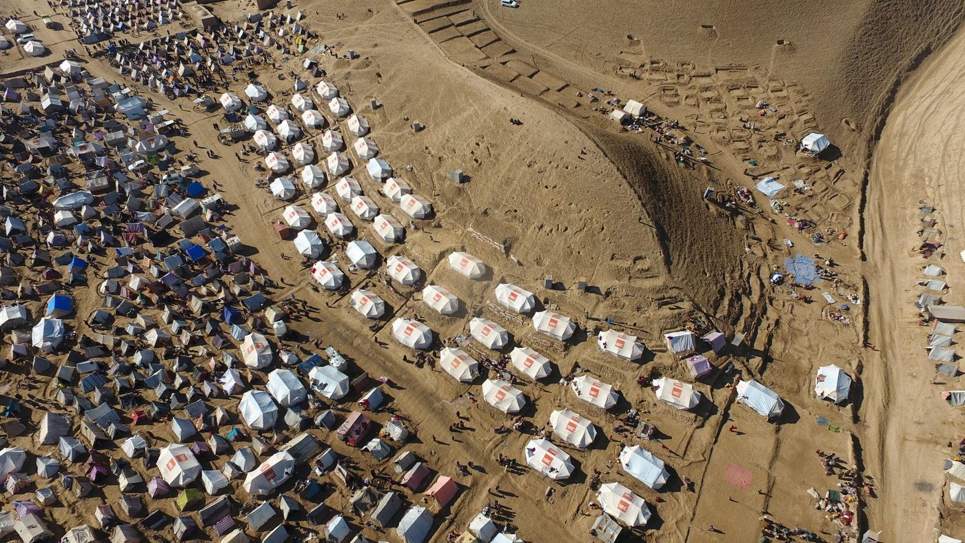This drone footage shows the size and scale of displaced family tents in one of the IDP settlement in Badghis. There are thousands of makeshift homes spread between mountain hills on the outskirt of Qala-i-naw city.
An estimated 150 thousand families from rural areas of Badghis have left their homes for Qala-i-naw as the ongoing drought and climate change struck their villages. As of November, a total of 340,406 people have been affected by natural disasters throughout Afghanistan and out of that, 158,000 have been displaced only in Badghis province.
Drought isn’t the only challenge that these families are fronting in the region; the deteriorating prolonged security situation has also added to their miseries. Many families can’t return to their homes fearing Taliban harassment and forced recruitment. The harsh winter conditions are a major challenge for the displaced families.
The families are living in seven different collective sites hoping to get humanitarian assistance. Many INGOs, including NRC and the UN bodies are involved in responding to the families. Based on UN OCHA, the first batch of 15,000 tents were delivered to Herat on 24 November. The distribution of tents in Badghis and Herat is underway by NRC and other NGOs for those who are in need of shelter. There will also be NFIs distribution for 10,000 households in both Herat and Badghis.
Photo: NRC/Enayatullah Azad