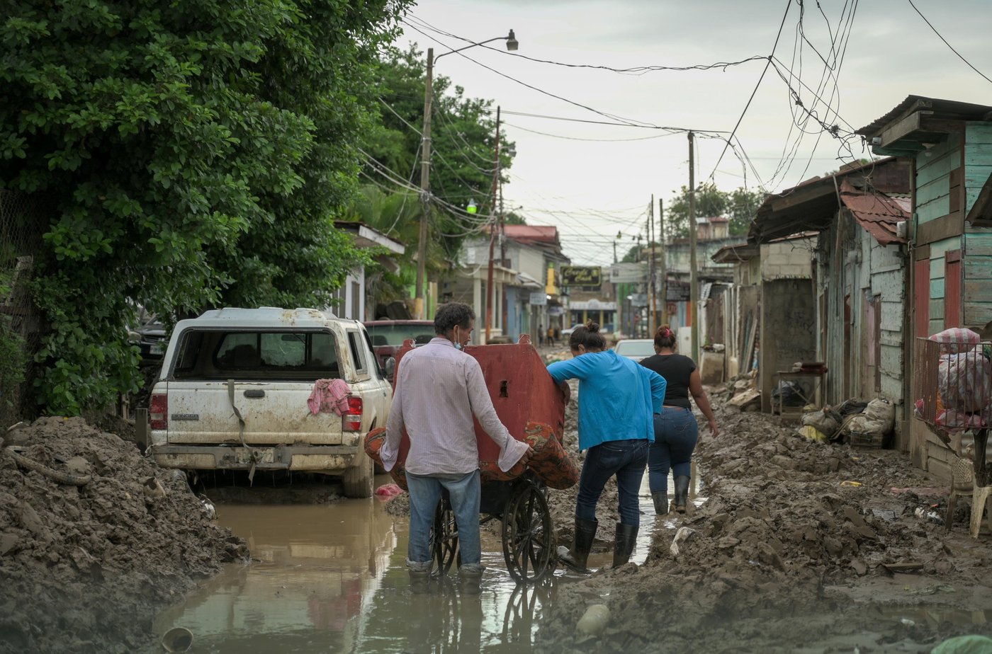 Thick mud blocks the way for a family who has been forced to flee their home in Honduras.