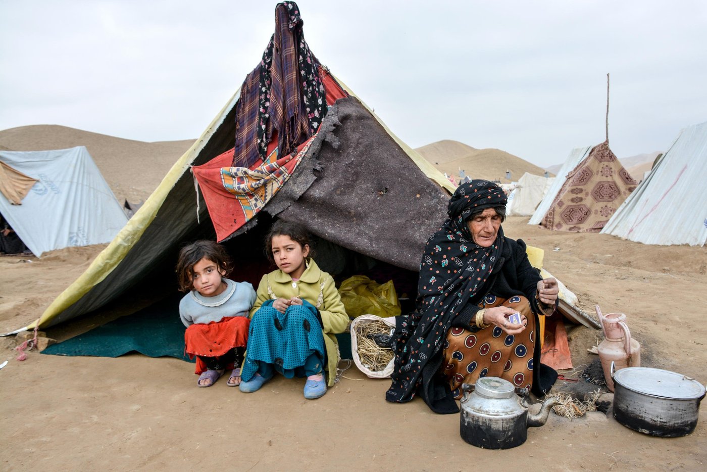 Gul Ghotay and her daughter Naseema and Naseema's friend Latifa in blue.

Gul Ghotay, a widow lives with her two daughters and a son in Feristan IDP settlement. Her husband died five year ago. Her oldest son is separated and living in Herat with his family. Her second son has become an opium addicts and she doesn’t know about his fate anymore. Zalmay, 17, her youngest son and her lost hope has been affected with Tuberculosis TB in the settlement. The family was living in substandard makeshift home in the river bed of Feristan settlement. 

Though Zalmay is suffering from Tuberculosis, but he is the only breadwinner for his family of four. He has recently started selling sandwich in the market. 
 

“we weren’t bothered by heat neither were we cold in our village. We are suffering all the time since we have been displaced. My son was healthy and now he coughs for hours or sometimes he brings out all his clothes and the other time he feels cold and asking me to put all the blankets over him. He acts weirdly and sometimes he doesn’t want to eat for days. The doctors say he has to eat plenty of fruits, vegetables and chicken meat, but the problem is that where can I get those all for him?”
 
“The doctors in Badghis told us to take him to Herat. We didn’t have enough to take him there. So I borrowed 10,000 AFN (Approx. $140) from my brother and took him there. The doctors give him some medicine and asked to visit them frequently.  Now I don’t have enough to take him in Herat or buy him medicine."


Zalmay, 17, is infected with tuberculosis in Feristan IDP settlement where he and his family lived for over five months. 

“I felt pain in the chest at the beginning and then was coughing. I didn’t tell my mom unless it got worst. I went to doctor and the doctors said I have been infected with tuberculosis. They gave me medicine for two months and asked me to visit them again. There have not been any changes or progress in my health. I still feel pain in my chest and coughing up blood.” 
Photo: NRC/Enayatullah Azad