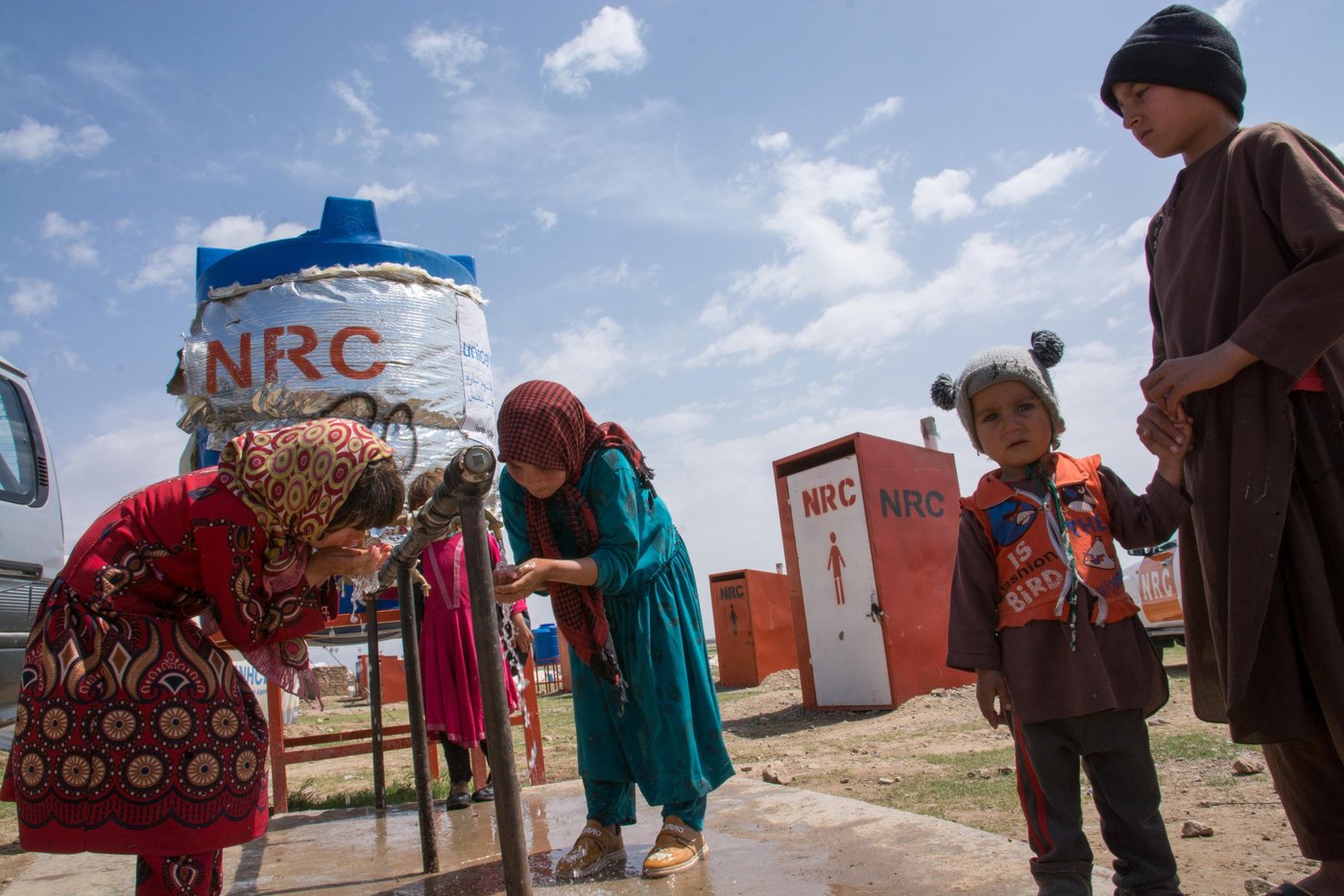 Norwegian Refugee Council (NRC) with support of the European Civil Protection and Humanitarian Aid (ECHO) supported the education program in the informal settlements in injil district of Hirat. 

Through a six-month grant from - December 2018 to May 2019, (ECHO) contributes to NRC Afghanistan’s ongoing education programme to further its reach and increase its positive impact on student beneficiaries through improved access to quality education in a protective environment. 

This program is carried out through establishment of learning spaces, recruitment and training of teachers as well as provision of education materials to facilitate the learning process.

NRC’s Herat Education team along with its WASH & Shelter program installed 20 educational tents (five tents in Shahrak e Sabz and fifteen tents in Faiz Abad) in Injil district of Herat. 

Shahrak-e-Sabz is a new location for the displaced community as the families were relocated due to land tenure related problems in December 2018. Currently up to 500 HH are living in this site. 

For each education tent, NRC provided two latrines (one female and one male), a 2,000 litters-water tank with stand, a latrine cleaning kit, and a hygiene kit. All education tents have been equipped with heaters during the colder winter months. 

During selection of EiE learners, NRC used vulnerability criteria to select priority students. This included out of school children, and children from those households that being targeted and supported through other NRC’s different program interventions. The students are mainly from Shahrak e Sabz and Kahdistan IDP settlement. Due to the high number of displaced families any more children than initially anticipated are now learning as part of NRC’s EiE proprgamme.

Currently, there are 535 (273 girls & 262 boys) students attending in 14 classes (5 tents) in 3 shifts. In each shift, there are around 38-40 students attending classes. 

Students are mostly Pashto speaking and Hirat is mainly a Dari spoken province.
Since EiE aims to empower displaced children with local language skills and to promote the social integration, NRC worked with a skilled curriculum developer to prepare a specific module of Dari conversation, stories, and vocabulary. Beside this, education has psychosocial support and BLP training to enable students to learn the stress release exercise and techniques. And assist them to be more focused and happier in their classes as well as their studies.
 
Some of the students were in school before the displacement and have studied as high as seven grades. Since the public school is far from the informal sites, families don’t allow their children, specially the girls, to go to the public school. Getting admitted to the public school can be difficult because the students lack identity cards and documents from the school in their place of origin. Also, thousands of families have arrived in one location and the current existing schools don’t have enough capacity to enrol new students.
Photo: Enayatullah Azad/NRC