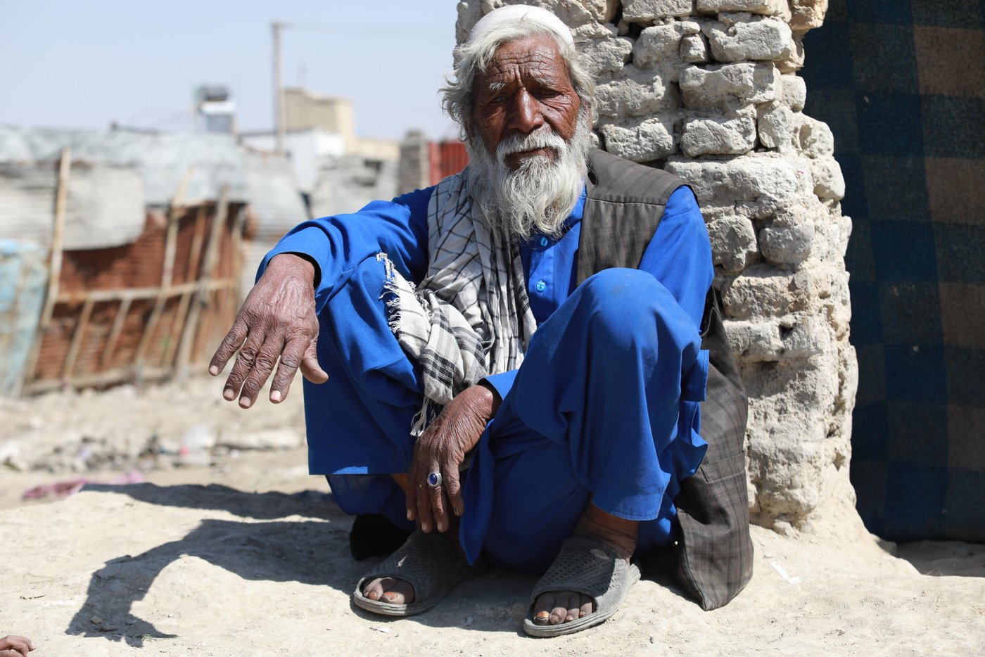 Sharbat Khan, 80, living in an IDP settlement in Kabul.
Quotes:
“We have heard that we should keep ourselves clean. Not touch out nose, mouth and eyes, but Allah is the savior and we can’t do to protect ourselves. I have left enough in this world and I’m not afraid of these diseases. We live our normal life and can’t cut or add anything to the routine. We can’t keep food as we can’t afford and there is no place to store them. We can neither limit our movement. They moment we stop our work, we no longer have in the hand to eat.” Photo: Enayatullah Azad/NRC