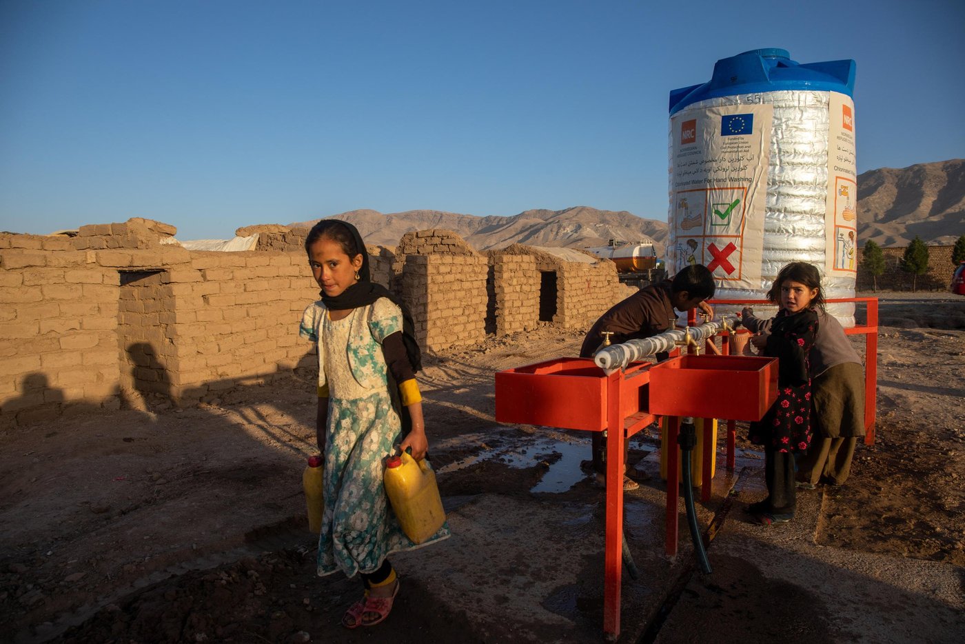 Mullah Mohammad Ayub, 42, is one of the countless displaced persons in Hirat whose heart is beating for his hometown, but can’t go there. He and his family of five are forced from his home in Bala Morghab district of Badghis province three years ago. Since then, they live in an IDP site for drought and conflict-affected families in Shaidayee camp. Some 7,000 households live in a private owned land in Shaidayee. Less than a kilometer to the east is another IDP camp that hosts an estimated 40,000 households named Shahrake-sabz. These families have been displaced from Badghis, Faryab and Ghor Province three years ago due to drought and conflict. 

Ayub desparately looks for the betterment of the security situation in Bala Morghab where he can go and start up with agricultural activities and livelihoods.  

“I follow the news of my hometown very closely through the radio. We don’t have electricity connections or a television here and I usually listen to the radio on my mobile phone that I charge with a small solar panel. There wasn’t any concerning news on my district and I went to see if I can go back to home with my family. I went there and I spent only one night. There was fighting ongoing and I was about to be killed. The security situation is volatile everywhere in the country and the media ignores many news if it is not the matter of collapsing a district center or a province.”

“It is very hard to live here and I have taken a lot of personal loans now. I am cleric and if I ask for a loan people do not say no to me. I have taken loans from my brother-in-law who lives in Turkey, cousins in Iran and people in Badghis. I have a rich and fertile field in Bala Morghab and if there is any chance to go back I can work hard and pay their money within two years or less. But we are stuck here. We can’t go back home and neither do we work here. If there is peace, I won’t stay here for one extra day. I don’t know if peace will prevail sometime soon in this country but I hope for it. This is not the life we do here. I was teaching students and we had everything in life we needed. Here, we do not even have water to wash our hands and face. We are very thankful to NRC for providing water for us. Accessing water was a great challenge for us, especially during the hot summer season. Children and women were providing water for the whole family. It was taking them hours to find a good willing neighbor who was helping us with a small water container. Sometimes we were also paying for water. Now, we have sufficient water at our doorstep. We have enough water for cooking and cleaning. We are not roaming around the camp for a water container and even the neighbors are happier that we are not disturbing them anymore.” 

Mullah Nohammad Ayub knows the importance of education and though he struggles to provide food for his family, he is keen to support his children get education. He has convinced the headmaster to admit her daughter and two more girls from the camp and teach them for free as there is no school in the camp for displaced children.

“Those who are running a school knows who we are and what is our financial status. I went to a private school nearby and explained that we can’t afford the fees you require and as their parents we have failed to provide them the education they are entitled to, but it is up to you now to help them along the right path. The headmaster offered scholarships for three girls. Now, my daughter, Bibi Amina, 8, and two of her friends Brishna, 10, which means (brightness) and Khanzada, 9, are attending class. We just provide stationaries and transportation for them. Education is very vital for children and will help them move out of poverty when they are young.”

When I asked him why is he look much older than his actual age and the reply was: “I have lost three sons in this war. Three young sons!”


Photo: Enayatullah Azad / NRC