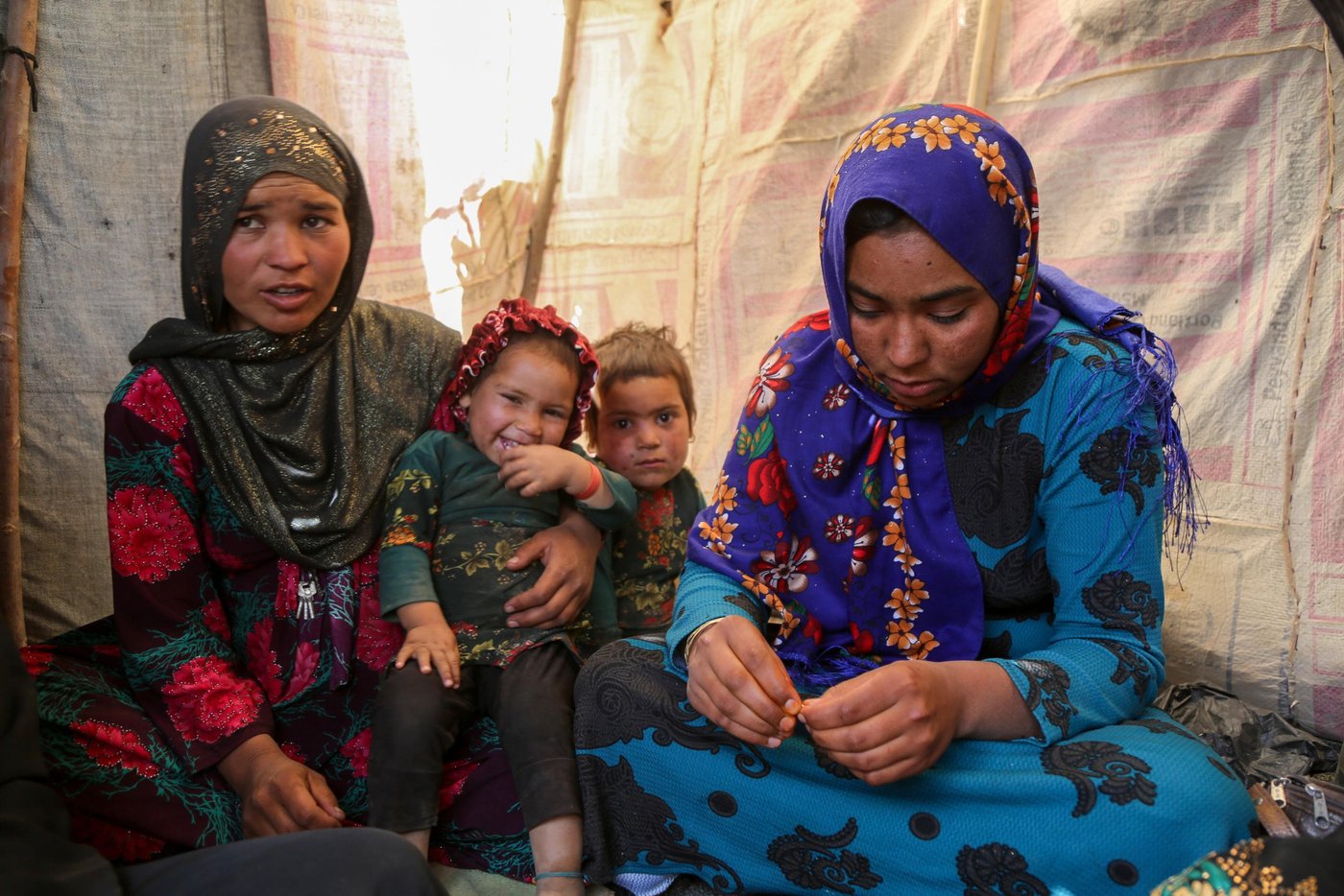 Sultana, 24, (right in blue) and Hajira, 32, (left in dotted red)
Sultana lost her three months daughter due to cold in one of the IDP settlement in Badghis, Afghanistan. The family have forced to come from Kharistan area to Qala-e-naw city due to sever drought some two months ago.
"My little was fine before we left the village. We came here and slept in the open with only a tarpaulin over our head. My daughter got pneumonia at the beginning and latter she died," said her mother grieving.
"She cries all the day and often comes here to talk to me and forget about her daughter," Hajira mother of five said.
"She lost her daughter due to cold and it made me worried not losing my children," she adds.
Hajira has five children and also a seven months pregnant. She asks for immediate shelter and winterization assistance as winter is looming.
"We can't go back to our home because we can't find even a drop water as all wells and water sources have dried up," she said when we asked if they are planning to go back. Though the family do not have proper shelter in Sanjetak settlement, but they have been provided with water tracking and water tanks.
PHoto: NRC/Enayatullah Azad