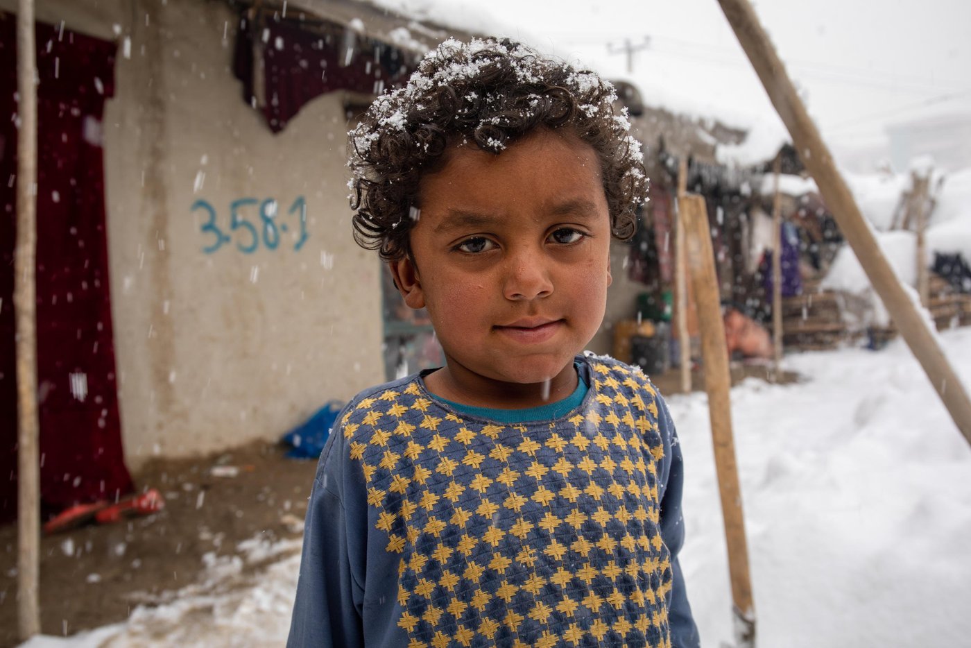 Hasibullah, 4, is Salma's brother.

"He has only one Jacket and I washed that thinking it won't snow sometimes soon," says her mother. "No he has to wait until it gets dried." 
"I'm afraid he might get sick as he doesn't have any spare jacket and he doesn't stay at home. he gets out every now and then to play with his friends and enjoy the snow." ended her mother. Photo: Enayatullah Azad/NRC