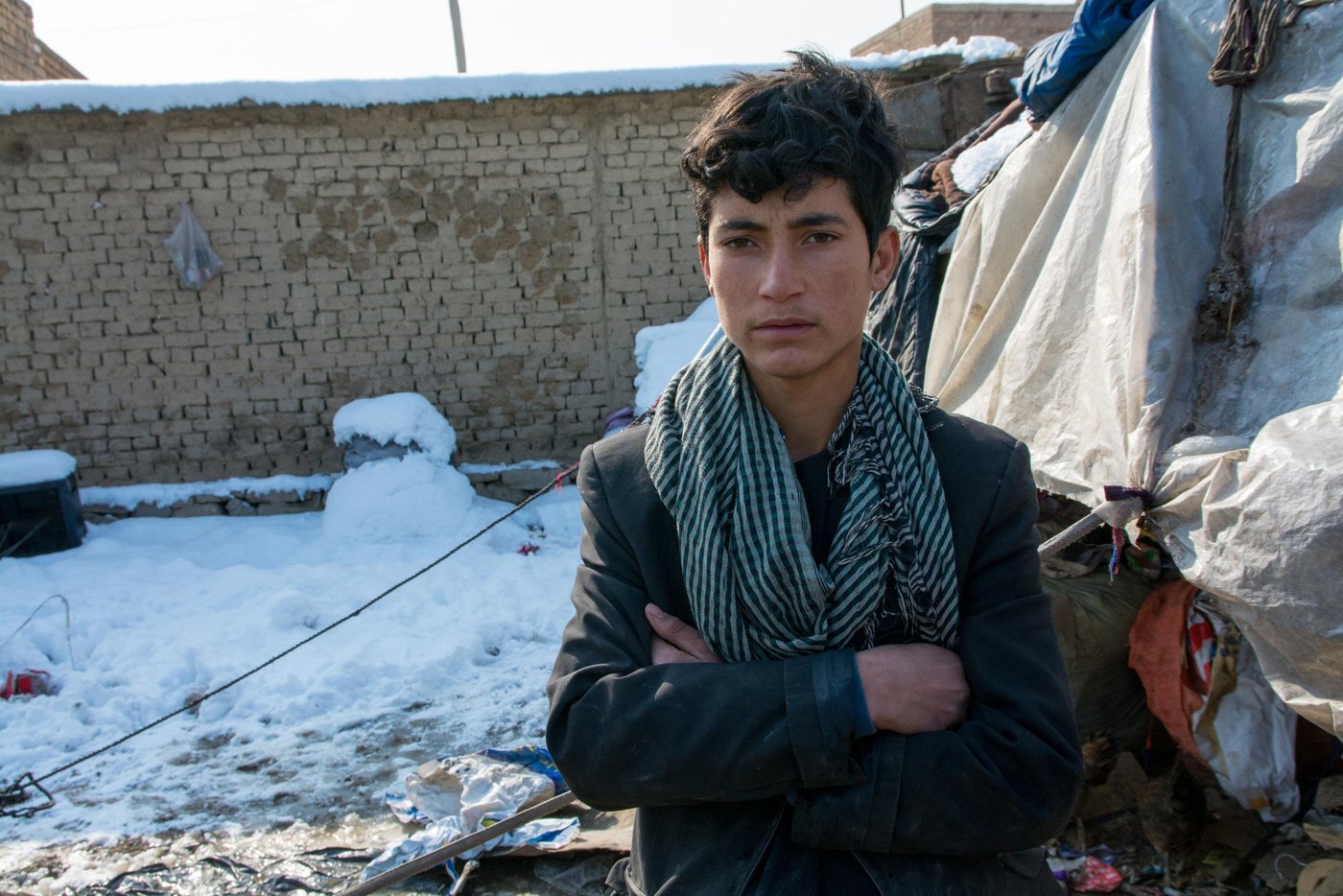 Naqibullah, 13, fled Kunduz with his eleven siblings two and half years ago, when the Kunduz provincial city was fallen to the Taliban.
Naqib and his family now live in a shelter was built on a rented yard by NRC. His family was provided with protection through secure tenure for a defined period of time and essential household items. His family was provided with access to safe household latrines and hand washing facilities and have access to sanitary latrines and received hygiene promotion trainings.
But Naqib and none of his siblings are now having the chance to attend school. Naqib was in second class when his family was forced to return to Afghanistan. It’s been four years now that he has been missed out classes.
Instead of attending class, he drives through the city with his bicycle and collecting scraps to help with family’s financial situation.
“There is no hope and I don’t have any future if I continue living in this situation. I don’t know about my future. Maybe I will simply be a laborer.”
Photo; NRC/Enayatullah Azad