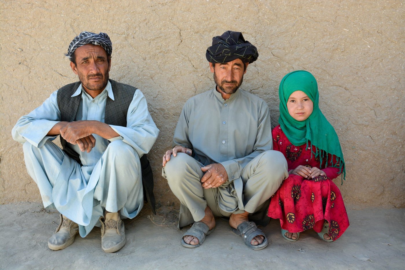 Sayed Gul Hussain, 42, with her daughter Zakira, 12, and his relative, Ismail Alambai.
Gul’s wife and three children managed to escape from the village, but two of her daughters was abducted with 235 other women and children by Taliban militants.
Hussain who managed to escape from the entrance of the village to the mountains said that he had spent two nights without food or water.
“My brother and I gave the children to women and tied them on back of our donkeys. When the militants blocked the village entrance, I managed to escape. My brother couldn’t leave his children. they took him and killed him later,” he said.
Now Gul Hussain, a farmer, has to take care of two families of twelve. Displaced from his farm and livelihoods, his prospects look bleak.
Photo: NRC/Enayatullah Azad