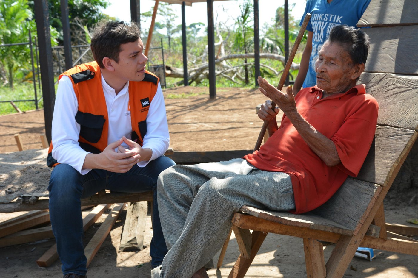L-R: David Garcia and Vicente (76) sit in the sun. Vicente explains the merits of the handmade basket his people have made for generations. It’s his job to teach his great grandson Andreas to make traditional handicrafts.
“All young people must learn,” he says. “They should all learn as I did before.”
But many of the old handicrafts that are traditional to the Jiw are dying out. The community has been uprooted from its ancestral land time and again because of the conflict. With each displacement, a little of their unique culture and traditions are lost.
In 2009, the Government classified the Jiw as one of the country’s 30 endangered tribes.
Forty years displaced
Some of the 17 families in this small community in El Salado have been displaced by violence since 1970.
Vicente, his daughter Luzdary (66) and Andreas are three generations of Jiw that have finally returned to their ancestral lands. They are part of a group that the Norwegian Refugee Council has helped to return to a place they can finally call home.
Neglected communities
A peace deal signed in Colombia in 2016 paved the way for the country to rebuild, after the decades-long war.
International organizations are keen to support, and funding is coming in for development projects like strengthening peace. However, small communities like the Jiw who are in humanitarian need have been somewhat neglected.
Building a future
The Norwegian Refugee Council has been working with the Jiw Community in the Guaviare region since September 2015. We are helping to rebuild homes for hundreds of displaceden, women and children returning to their ancestral lands. We provide free legal counseling so that people know their rights on land issues. We also support children to return to school.
Date: February 2017
Photo credit: NRC / Michelle Delaney
Text: michelle.delaney@nrc.no