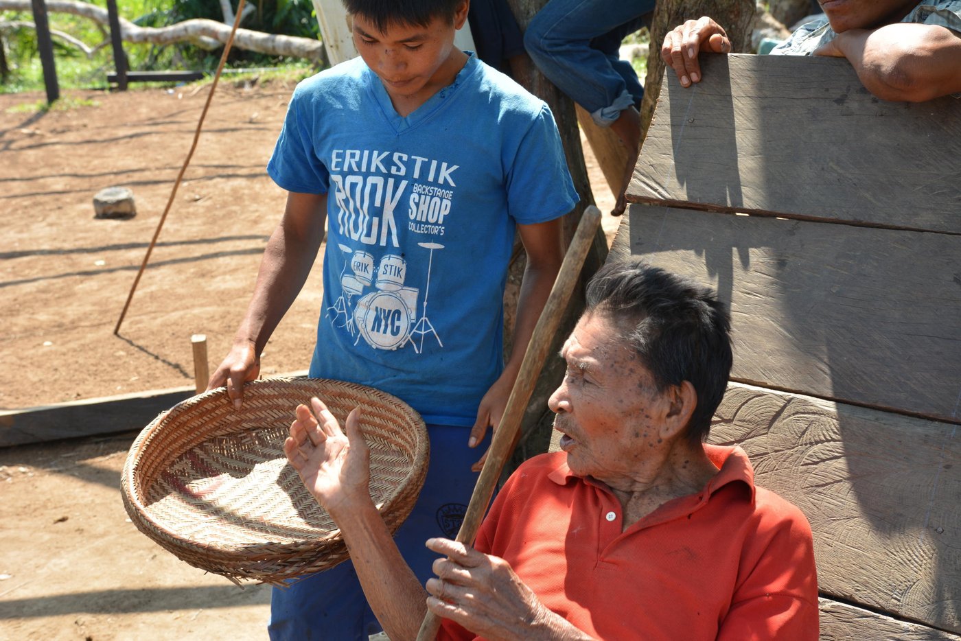 Vicente (76) sits in the sun. He explains the merits of the handmade basket his people have made for generations. It’s his job to teach his great grandson Andreas to make traditional handicrafts.
“All young people must learn,” he says. “They should all learn as I did before.”
But many of the old handicrafts that are traditional to the Jiw are dying out. The community has been uprooted from its ancestral land time and again because of the conflict. With each displacement, a little of their unique culture and traditions are lost.
In 2009, the Government classified the Jiw as one of the country’s 30 endangered tribes.
Forty years displaced
Some of the 17 families in this small community in El Salado have been displaced by violence since 1970.
Vicente, his daughter Luzdary (66) and Andreas are three generations of Jiw that have finally returned to their ancestral lands. They are part of a group that the Norwegian Refugee Council has helped to return to a place they can finally call home.
Traditionally a hunting tribe, Andreas proudly shows off a spear he uses for hunting.
“There are fewer animals nowadays than before though, and the men in the community must walk up to 8 hours when they go to hunt meat to feed the community,” says Andreas.
Andreas wants to work with computers when he finishes school. “People who work on computers make more money,” he laughs.
Vicente recognizes that the numbers of their people are falling. “Some families were as big as 50 people before,” he recalls. “But now are as small as 30. They left for the towns.”
Neglected communities
A peace deal signed in Colombia in 2016 paved the way for the country to rebuild, after the decades-long war.
International organizations are keen to support, and funding is coming in for development projects like strengthening peace. However, small communities like the Jiw who are in humanitarian need have been somewhat neglected.
Building a future
The Norwegian Refugee Council has been working with the Jiw Community in the Guaviare region since September 2015. We are helping to rebuild homes for hundreds of displaceden, women and children returning to their ancestral lands. We provide free legal counseling so that people know their rights on land issues. We also support children to return to school.
Date: February 2017
Photo credit: NRC / Michelle Delaney
Text: michelle.delaney@nrc.no