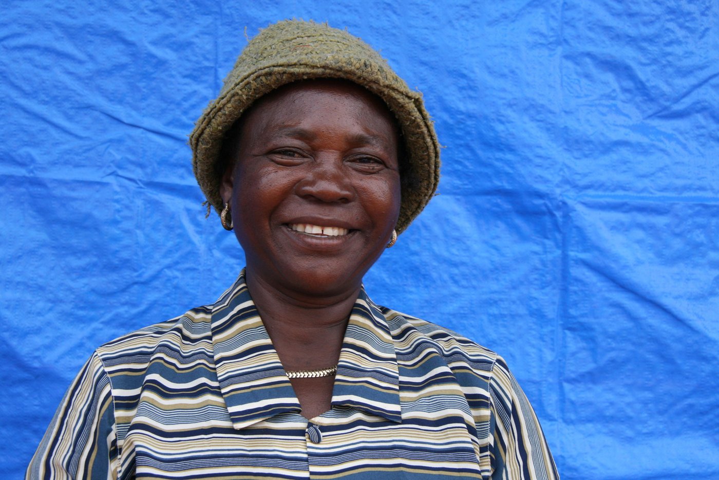 Fifty-eight-year-old Bernadette Ebambi is a mother of seven children. She fled to Kalemie city when fighting broke out in her home village of Kabulo, in Tanganyika province where insecurity has drastically deteriorated because of intercommunal clashes since 2017.
In February 2018, Bernadette has benefited our Cash assistance in Kalemie.
“I have received US $55 which has allowed me to buy food and clothes for my kids”, said Bernadette Ebambi. Also, the woman of Fifty-eight-year-old has been capable to pay one part of the school fees for her two children.
With Unicef support, NRC has assisted over 8,000 displaced families with Cash in Kalemie city. Easy and quicker to deliver aid, it has given the beneficiaries the chance to decide what is necessary and important for their life.
Since October 2017, Tanganyika province has been classified as an L3 area by the UN. Despite of that, the region has not yet got adequate resources to tackle the immense and horrifying needs.
Donors and humanitarian community should urgently act to allow aid agencies to scale up adequate responses and deliver aid to thousands of displaced people currently trapped in spontaneous settlement site across Tanganyika province.
Photo NRC/Ephrem Chiruza. February 2018