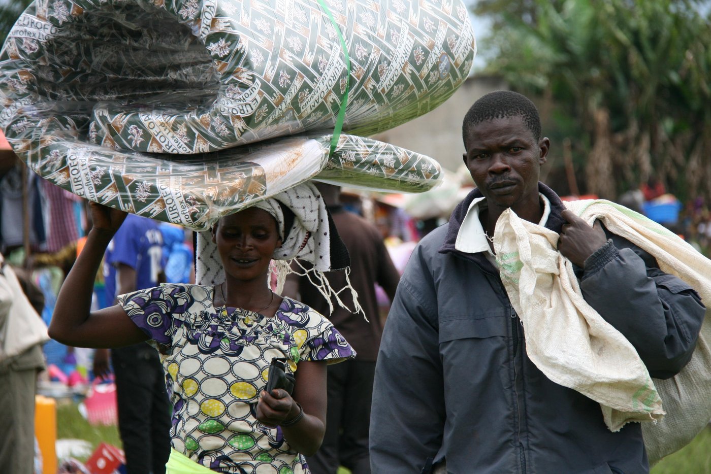 Kawambe (left) and his husband Jean Marie Kisanono (right) are both displaced from Djugu territory, in the east of DR Congo where early in 2018 spreading of violence has forced thousands of families to flee from their homes.
“During the clashes in my home village, my house were burned and the bandits went with my belongings. Because of this conflict, my children were obliged to drop from school”, says Kisanano, father of five children.
With funding from UNICEF, the couple has benefited NRC assistance (essential household items). Thanks to this aid, the couple has bought a new mattress; pans and clothes.
In late April and early May 2018, NRC has provided nonfood assistance to over 14,000 displaced and host families in Bunia, Mahagi and Djugu territories, Ituri province in the east of DRC.
NRC has delivered this aid through markets fair where beneficiaries have freely purchased essential household items like pots, pans, mattress, blankets, clothes, etc. Results made possible with UNICEF support via the RRMP8.
RRMP, a humanitarian approach based on a cooperation between humanitarian organisations, managed by UNICEF, was created in 2004 to ensure rapid responses to the humanitarian needs of displaced populations in DR Congo. The programme targets people who have been displaced for three months or less without any assistance.
Photo: NRC/Ephrem Chiruza. April 2018