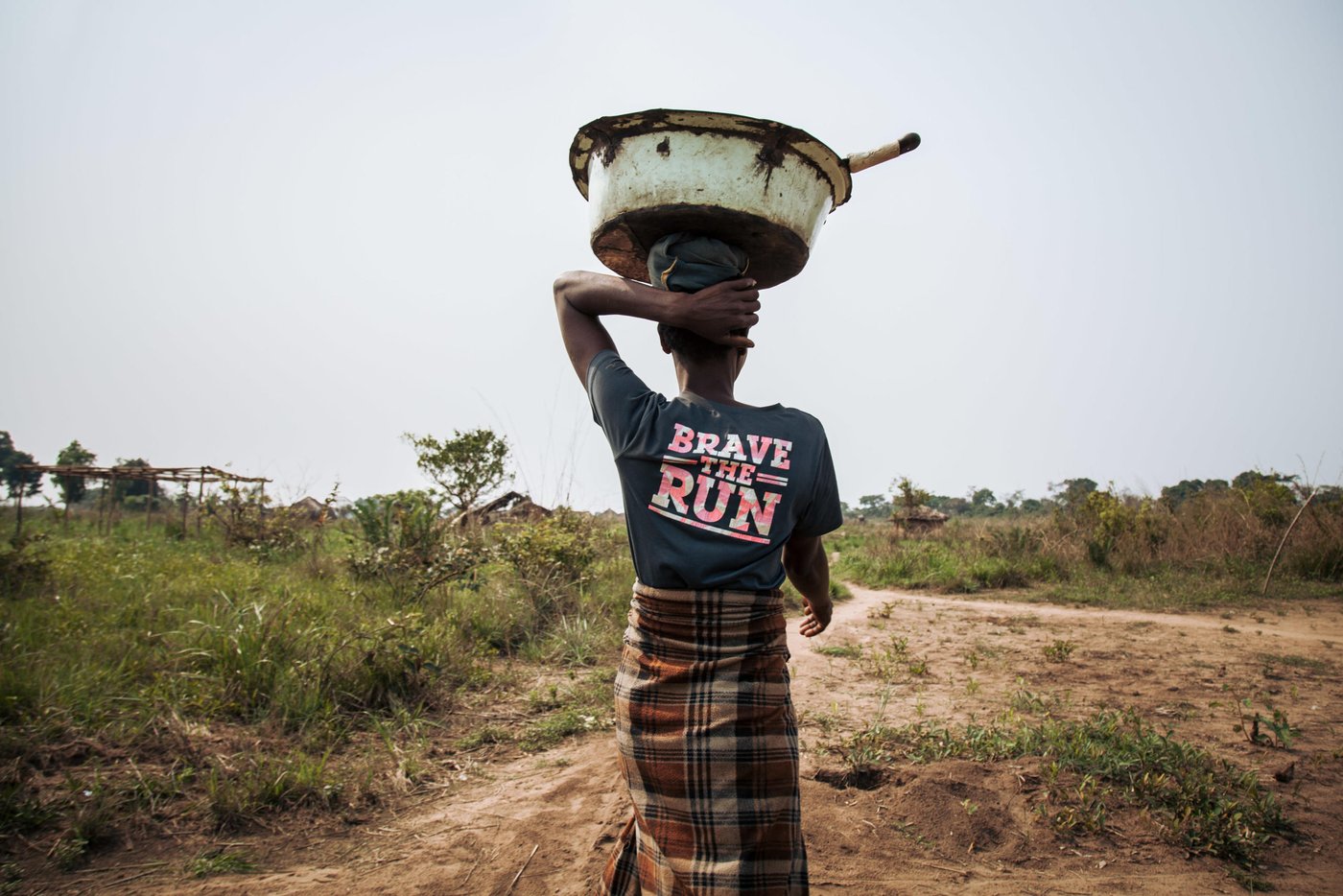Sangamai Teka, 41, walks to the small plot of land where she plants "ndembe" (red beans).  She and several other female farmers who were displaced during the Greater Kasai conflict of 2016-2017 have returned to less than they had before.   Many of these women have lost children and spouses to the conflict.  All of them struggle to make a living to sustain their families.

Over 1 million people have returned to their homes in Kasai-Central after a year of violent conflict within the province and across the Greater Kasai Region.  Unfortunately, people who have returned have found their homes and fields pillaged and burned to the ground.  These farming communities have no shelter, no food to eat and no means of sustaining any viable livelihood.

Earlier this year, NRC visited Mbulungu and Bakuakashila, two villages ravaged by the regional conflict in 2017.  NRC used its “community-based approach” by consulting with these communities to better understand their primary needs, to properly target the most vulnerable people and facilitate their ability to choose the assistance they require.

This intervention, however, is only a drop in the ocean of the vast needs of this community.  NRC is currently the only humanitarian actor in the zone and funding is not enough to address other acute needs such as food assistance, household items and education.  The Humanitarian Response Plan is currently only 25 per cent funded eight months into the year.  Humanitarian capacity is critically low.  If donors do not act now for the people of Mbulungu and for the rest of DR Congo, it will be too late.

August 29, 2018- Kasai-Central Province, DR Congo
Photo : NRC/Aléxis Huguet